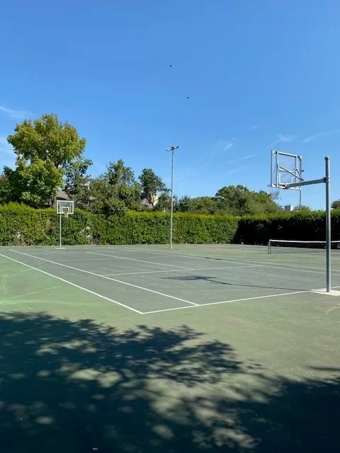 View of tennis court featuring community basketball court