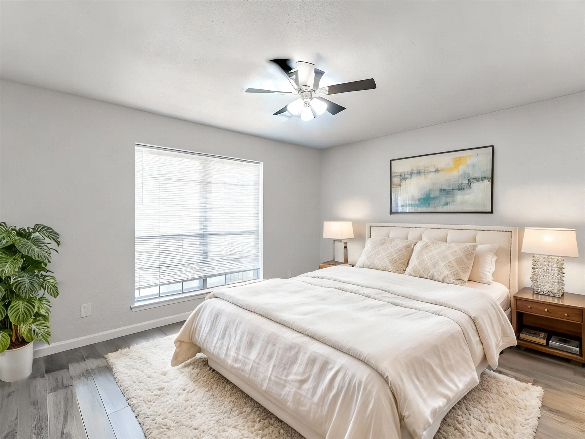 Bedroom 1 featuring light wood-style floors and a ceiling fan