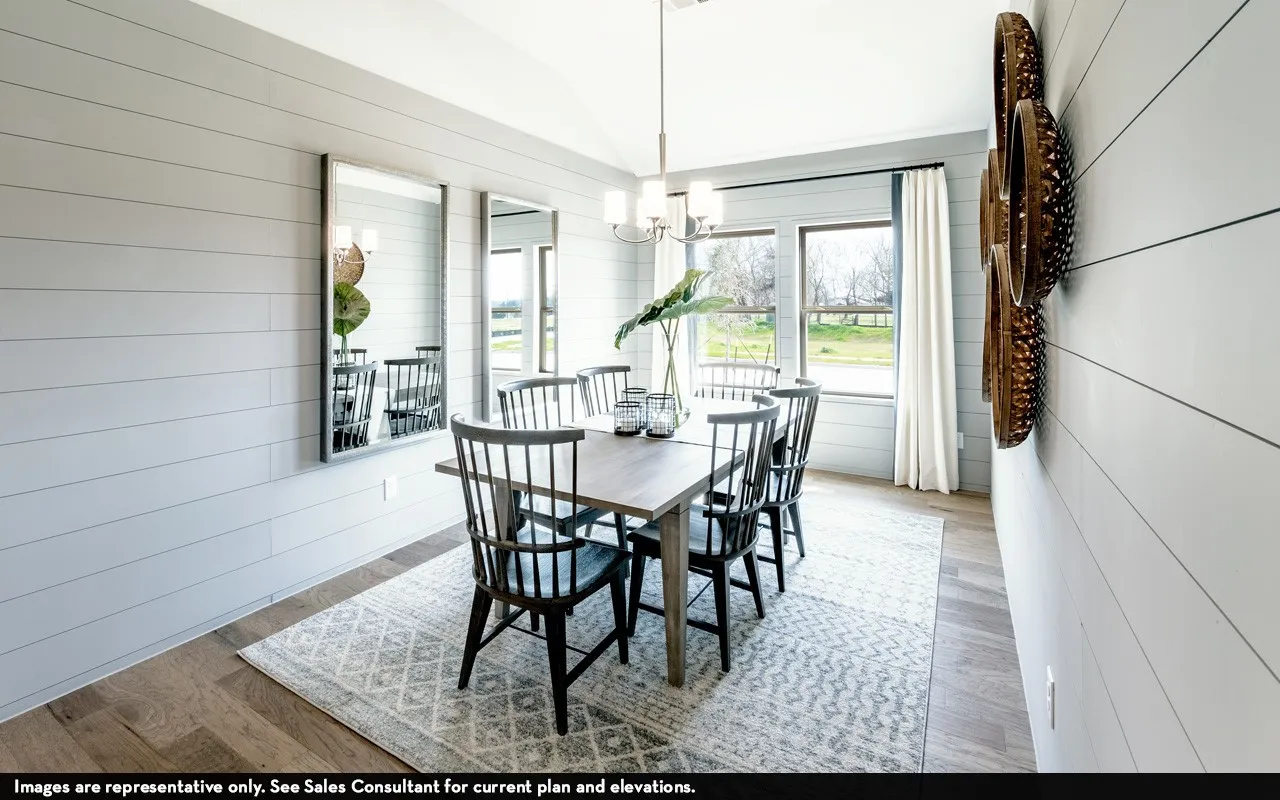 Dining area featuring shiplap accent walls, wood-finish flooring, and a vaulted ceiling with a chandelier