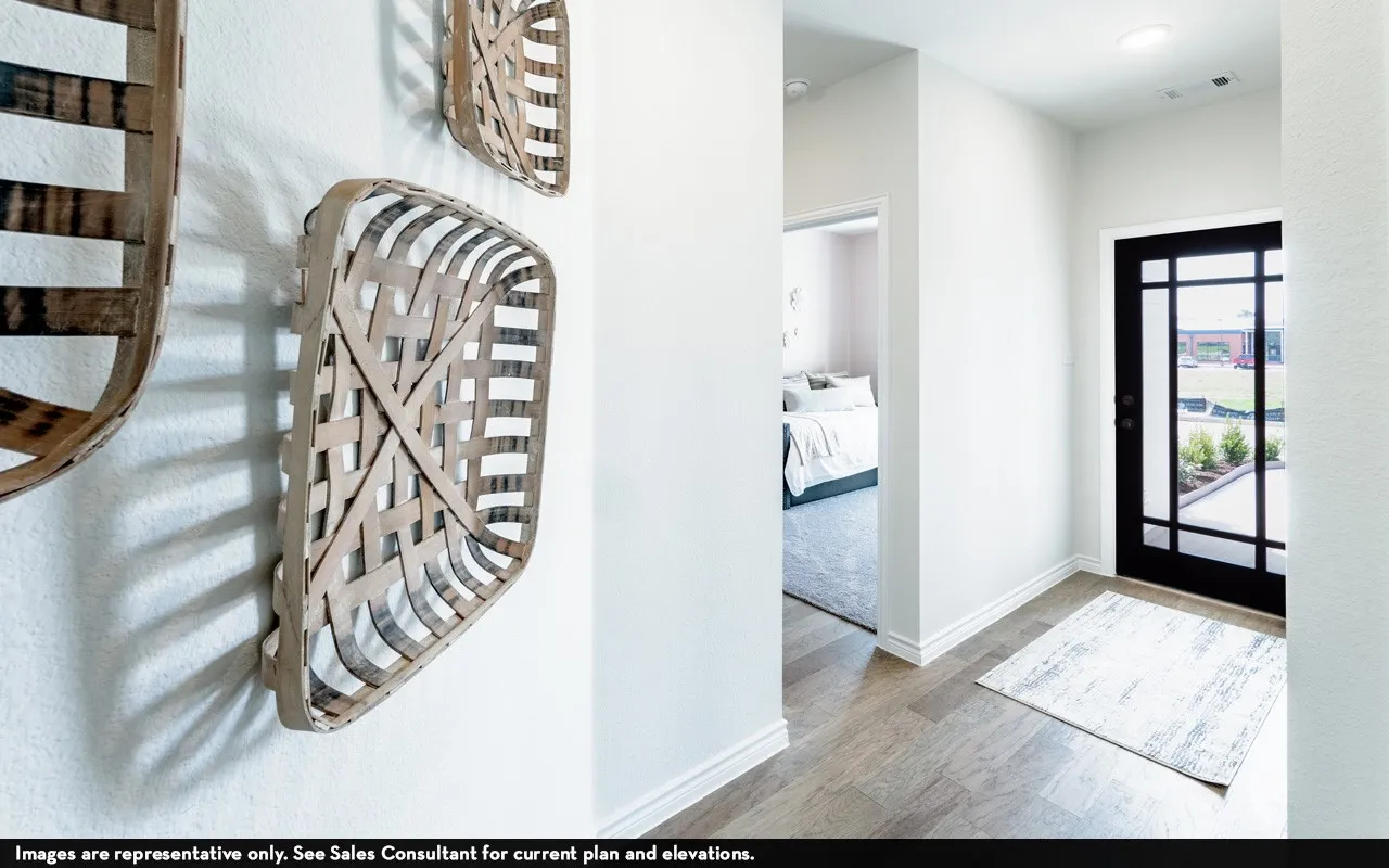 Wood-finish flooring, white baseboards, recessed lighting, and a black front door with glass panels