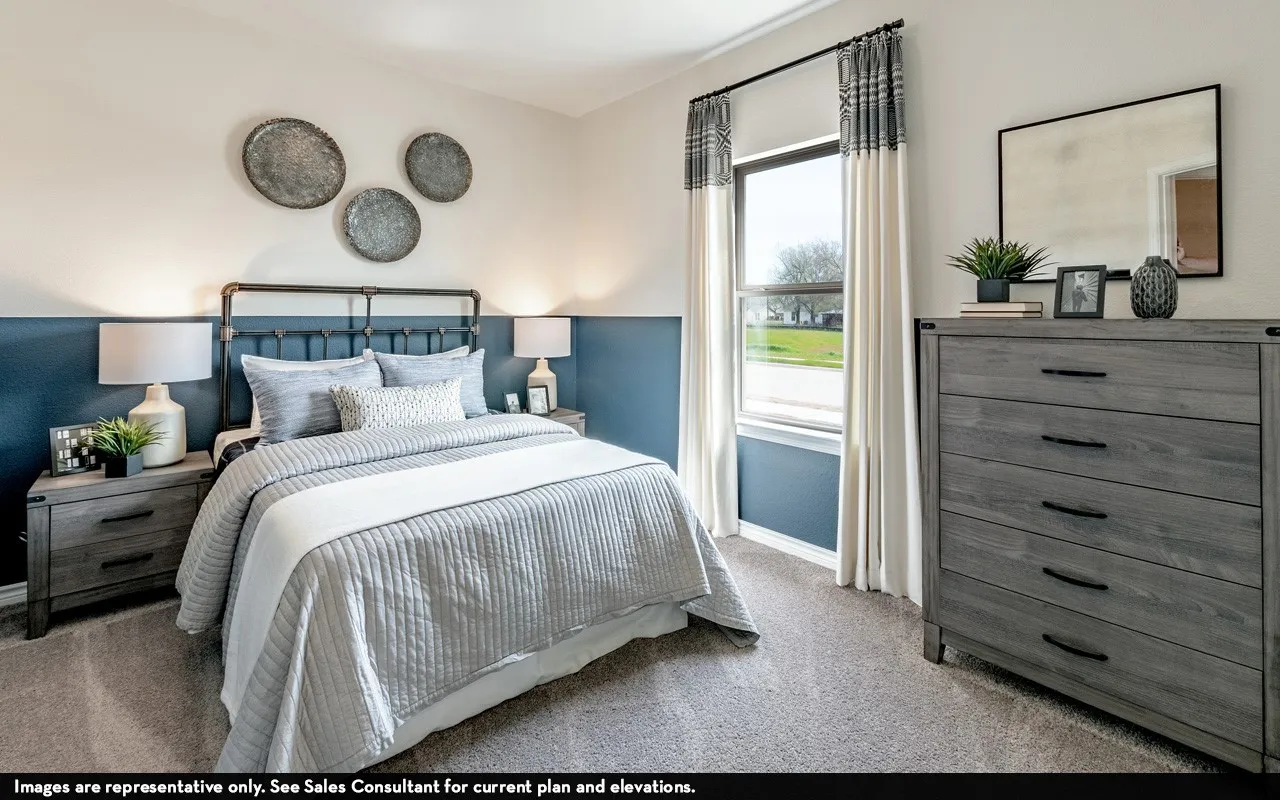 Carpeted flooring, two-tone wall treatment, and a window with curtains