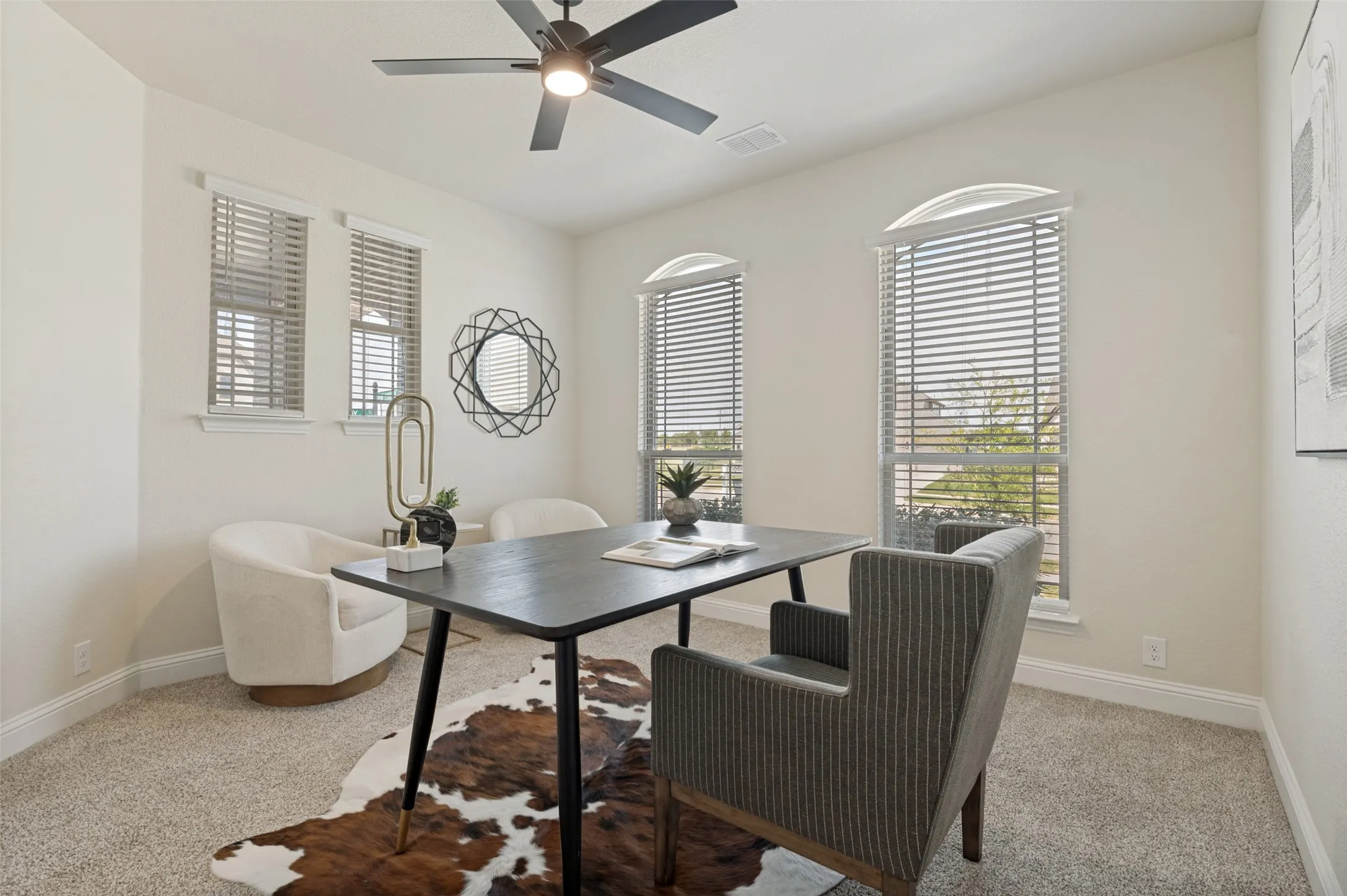 Recessed lighting, arched window, a ceiling fan, and carpeted flooring