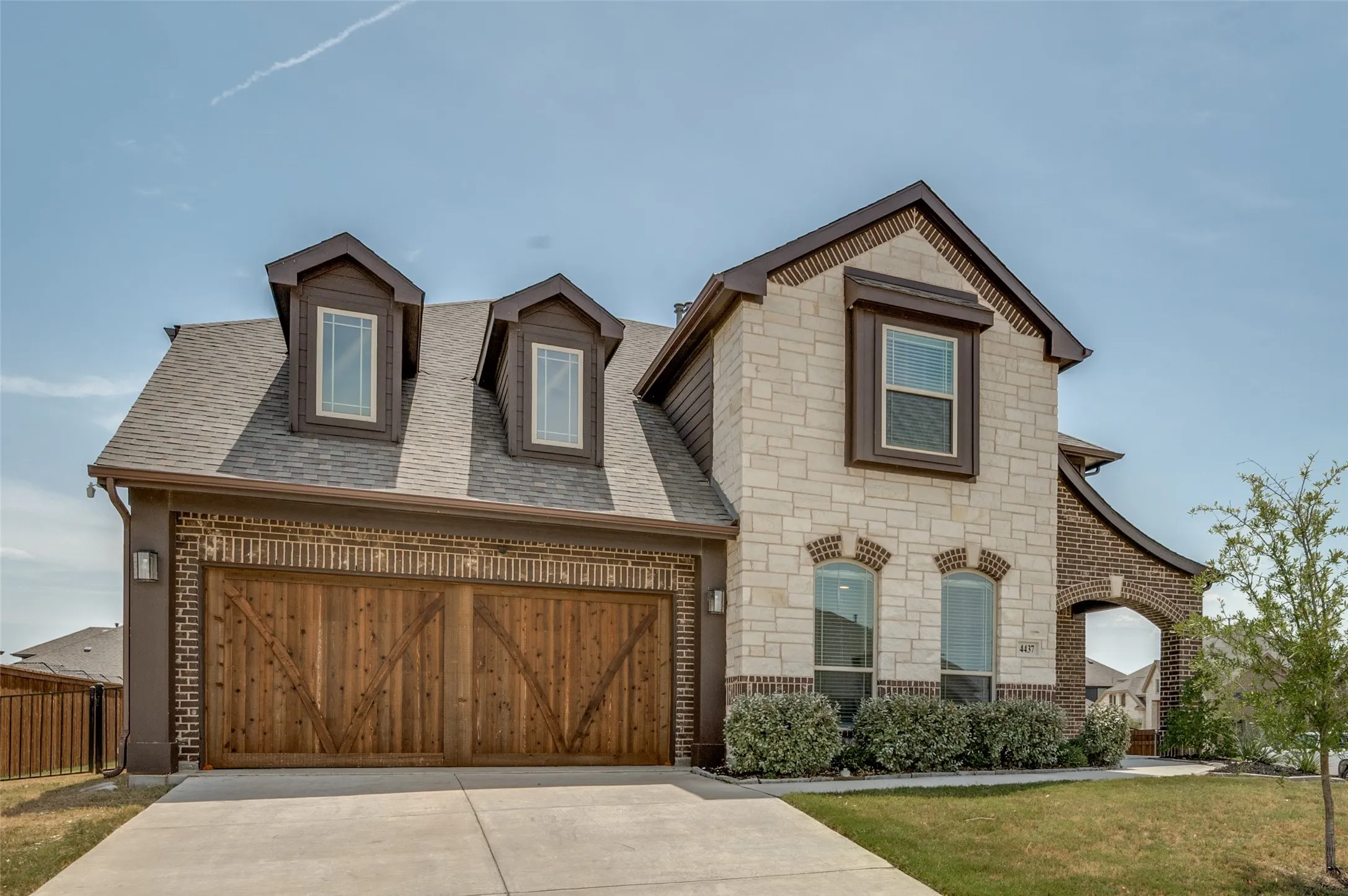 Stone and brick exterior with a prominent arched entry