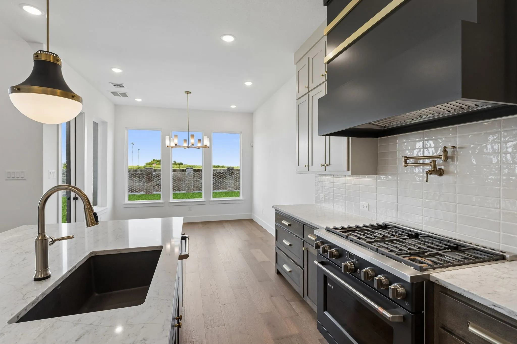 Beautiful two tone cabinetry, gorgeous counter tops and classic backsplash effortlessly pair with high end appliances to create a dream kitchen for the ages!