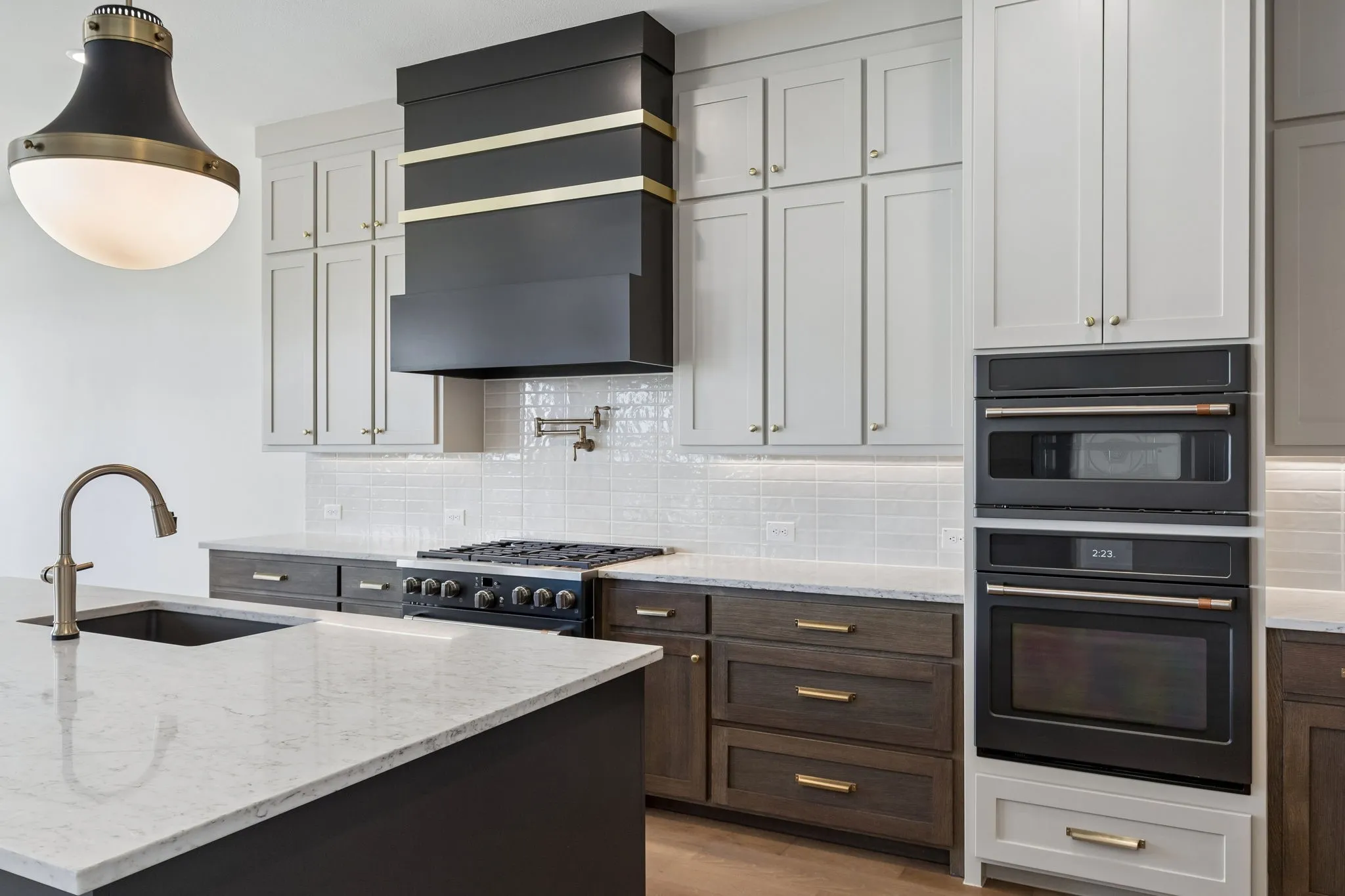Featuring a striking mix of light and dark cabinets plus modern black stainless steel appliances, any chef would be proud to call this dream kitchen their own!
