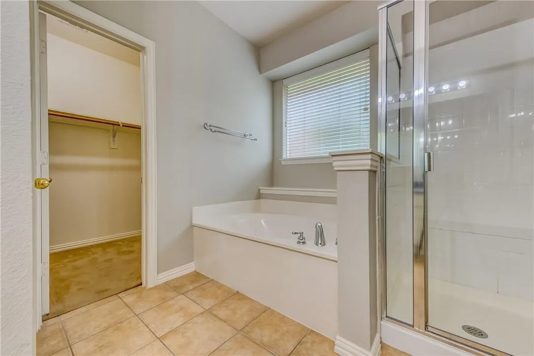 Bathroom with tile floors and separate shower and tub