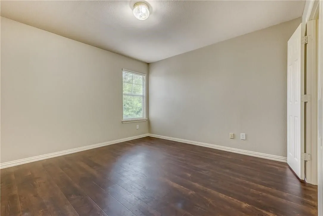 Unfurnished room featuring dark hardwood / wood-style flooring