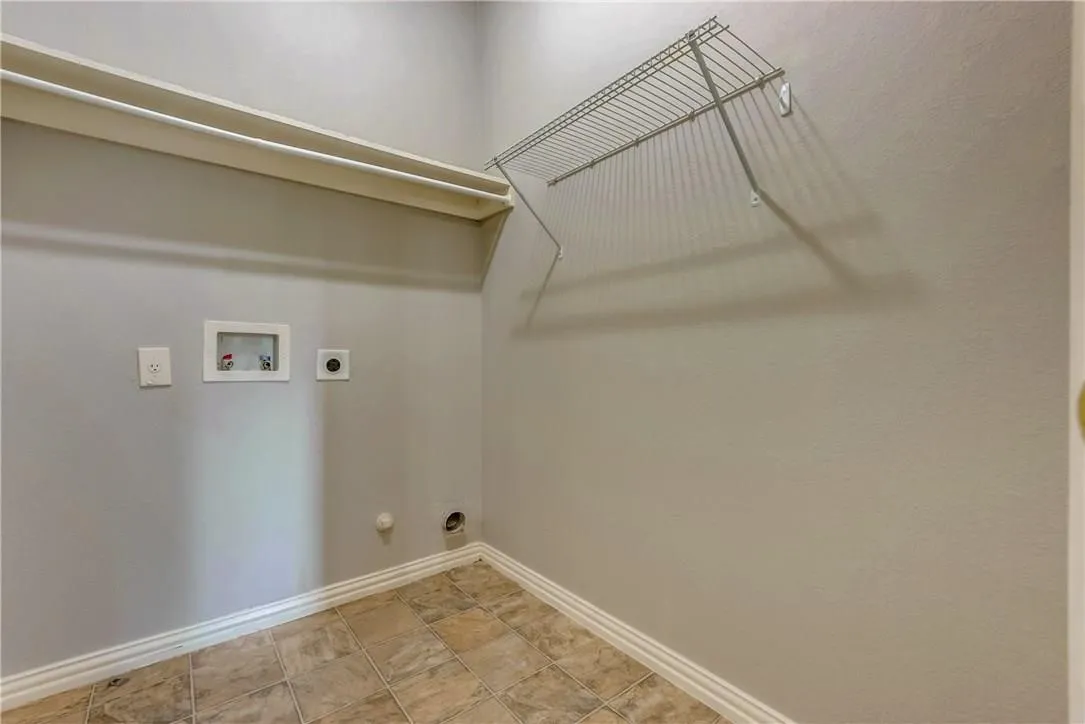 Laundry area with gas dryer hookup, washer hookup, light tile floors, and electric dryer hookup