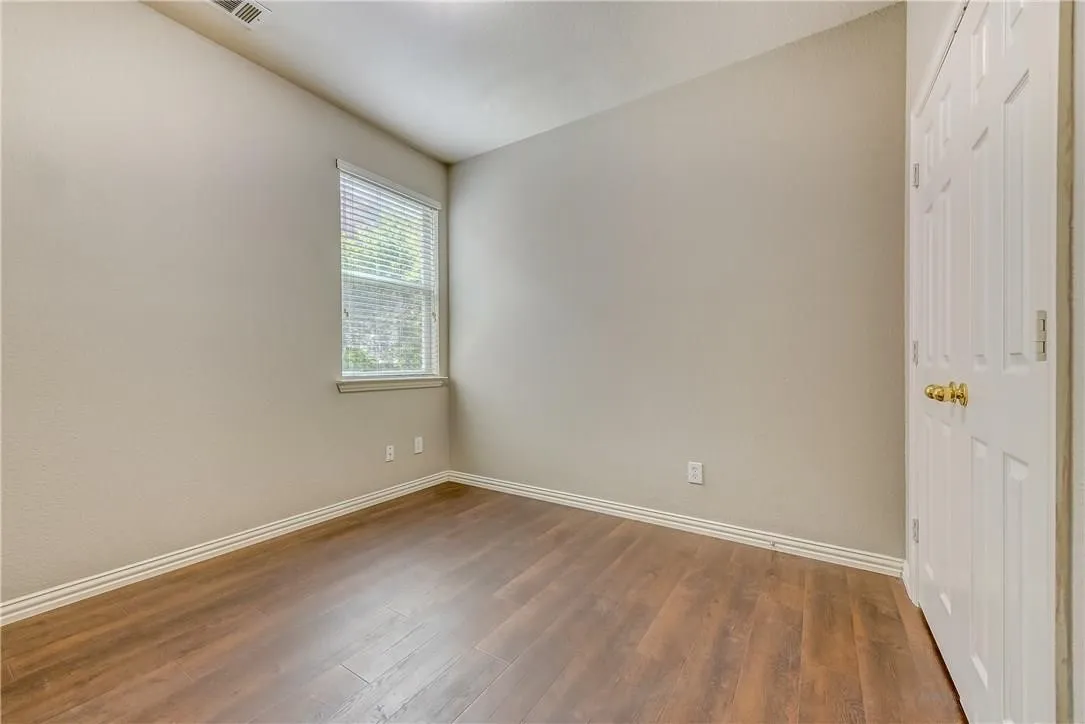 Spare room featuring wood-type flooring
