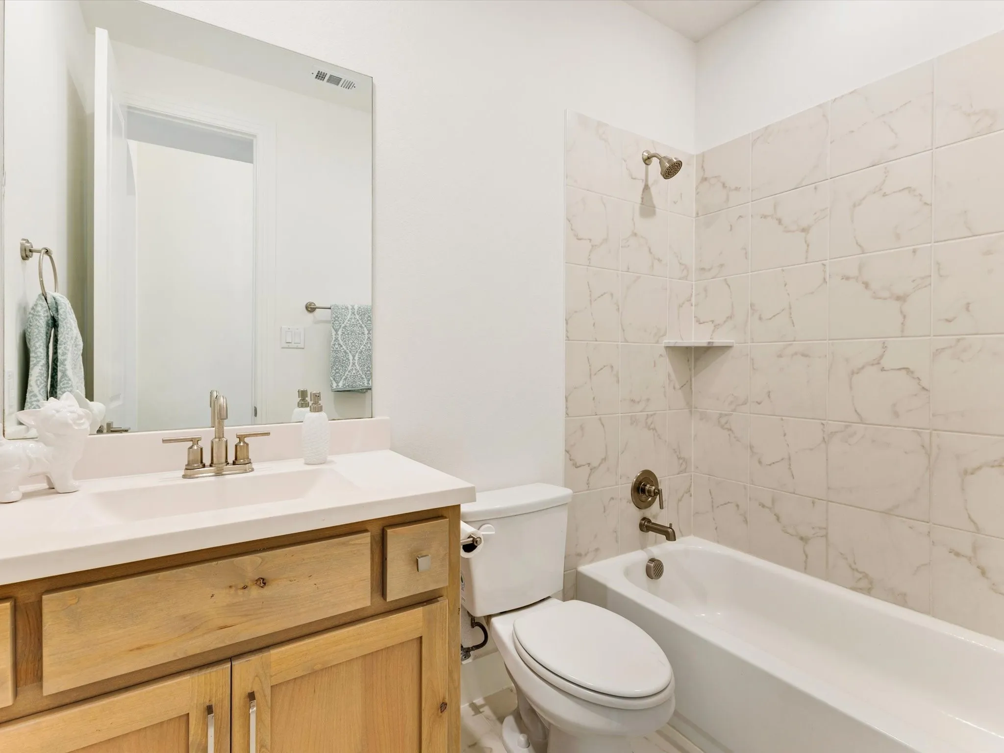 Wood-finish vanity with a single basin, undermount sink, and brushed nickel fixtures