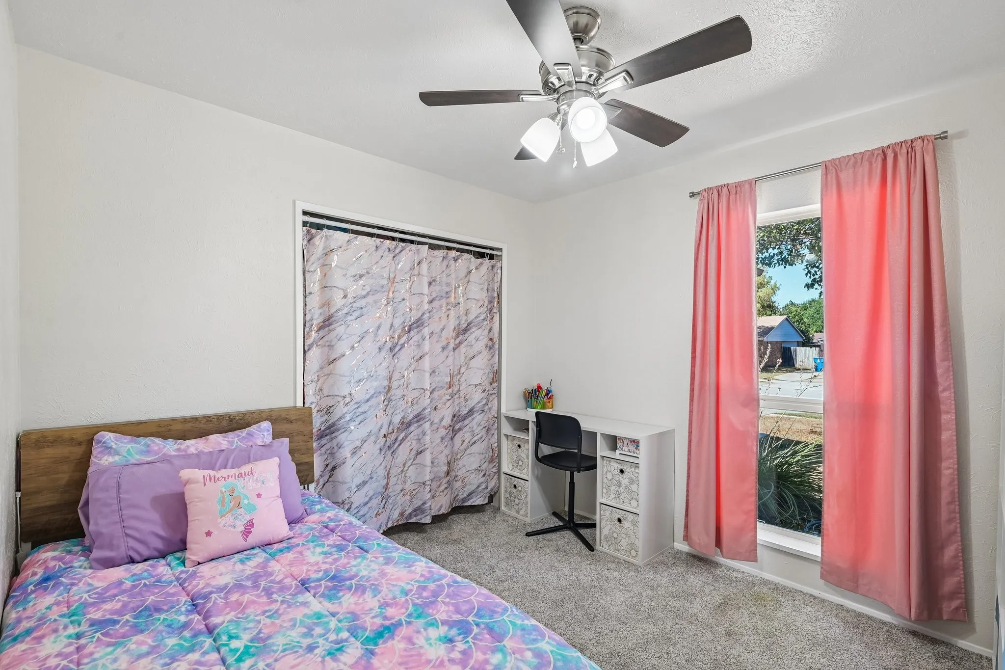 White painted walls, light gray carpet, and a ceiling fan with integrated lighting