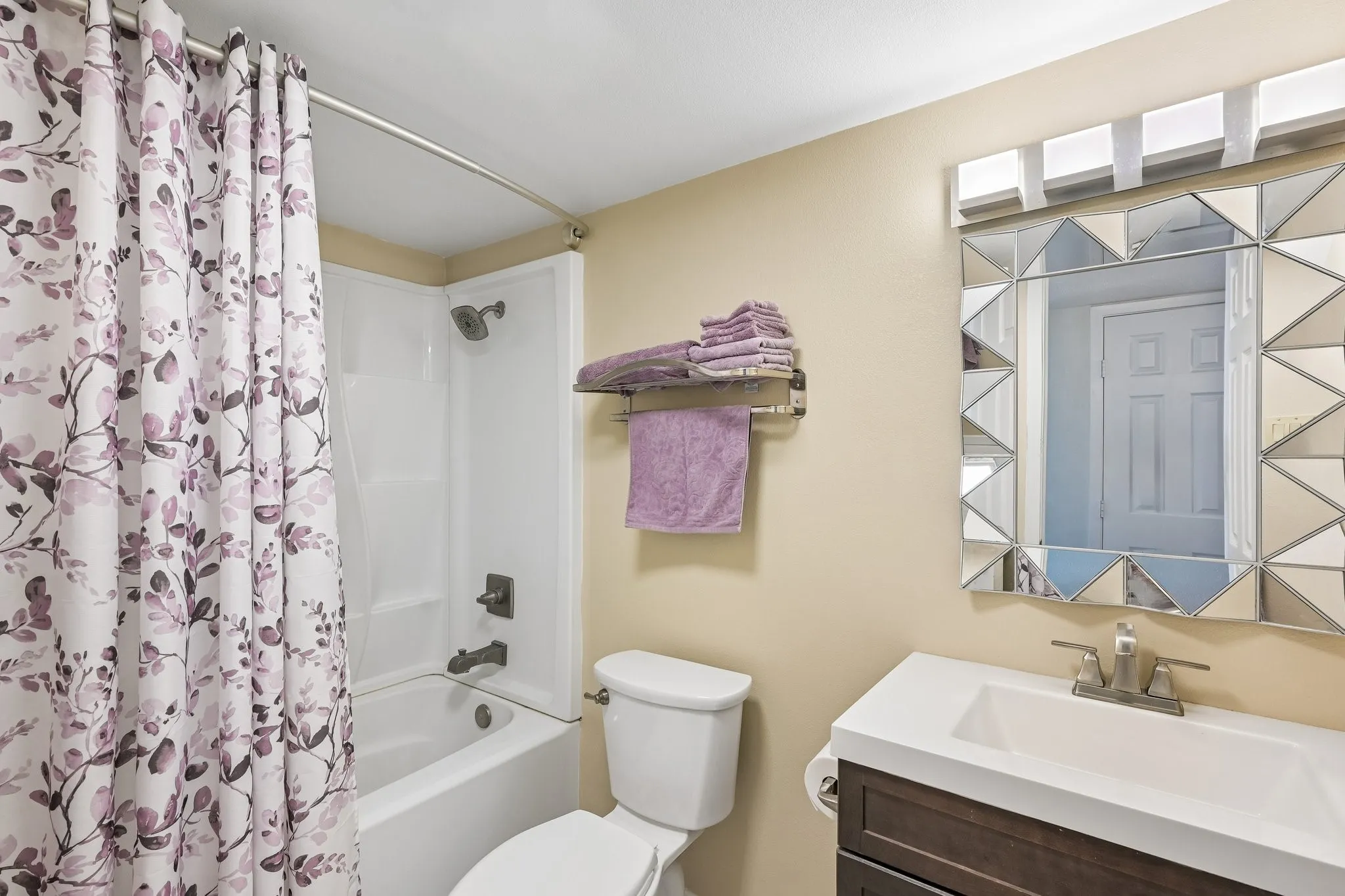 White tub and shower combination with dark bronze-finish fixtures