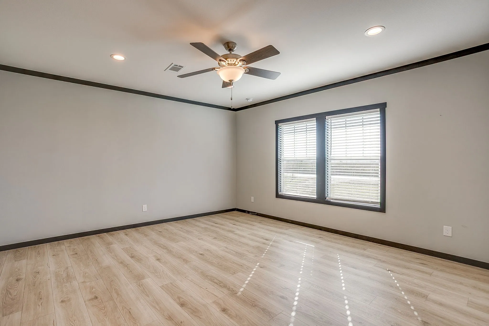 Wood-finish flooring, recessed lighting, ceiling fan, and dual windows with blinds