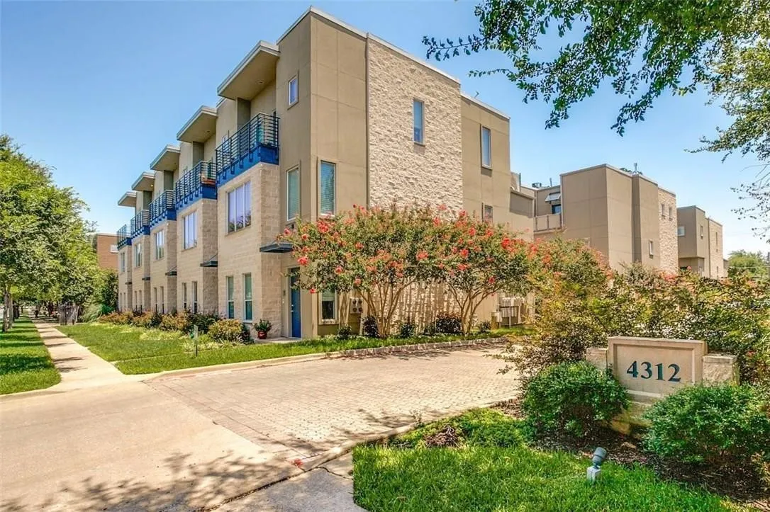 Modern multi-story facade featuring stone and stucco finishes