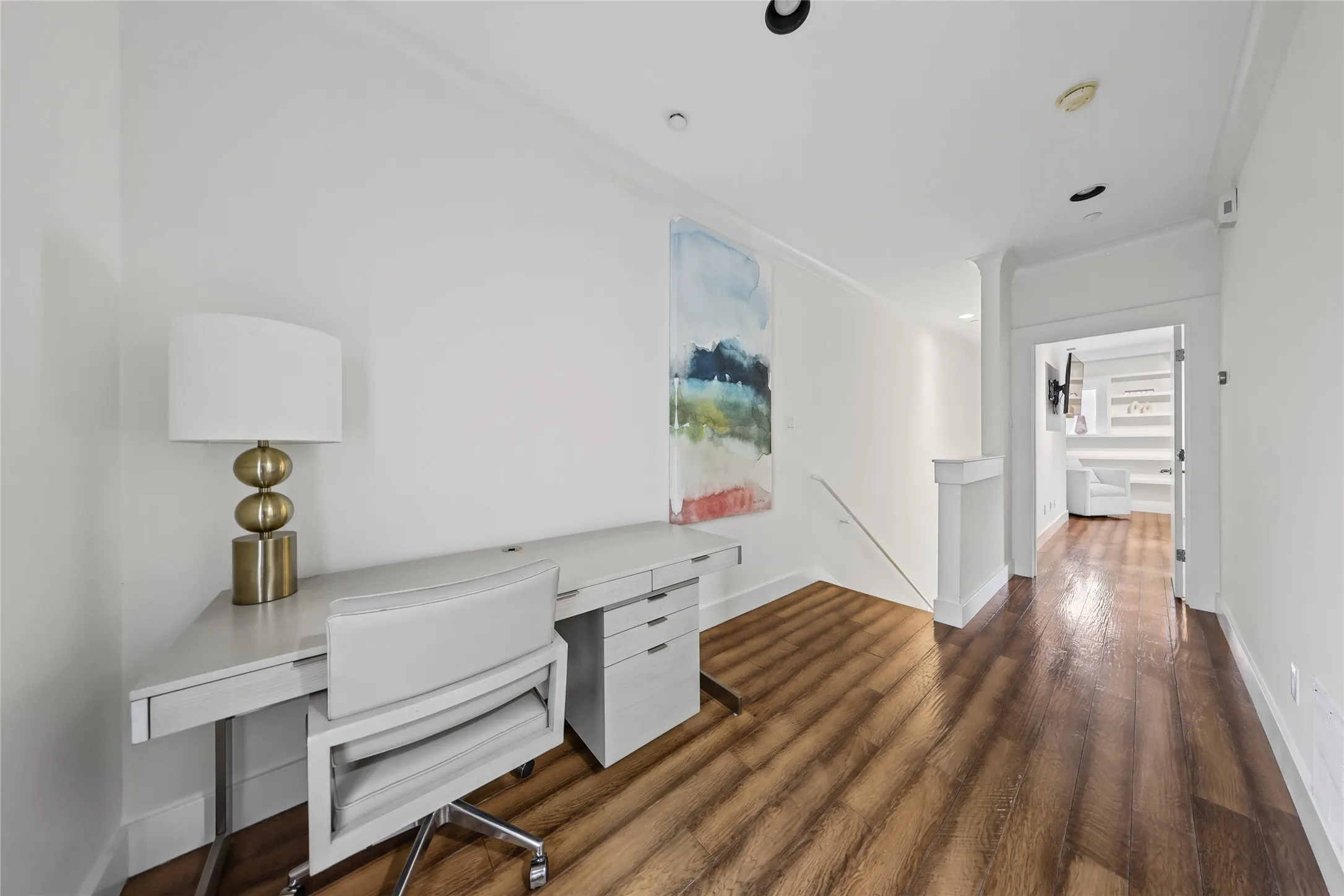 Wood-finish flooring, white walls, and recessed lighting