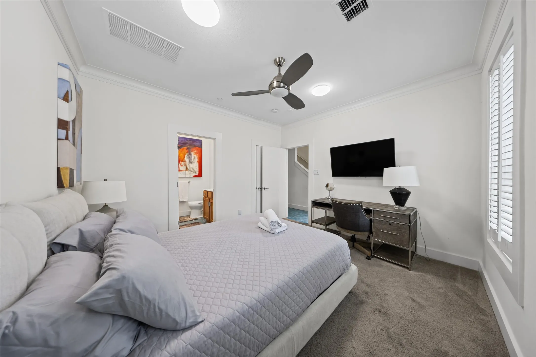 Recessed lighting, crown molding, gray carpeting, and a ceiling fan with integrated lighting
