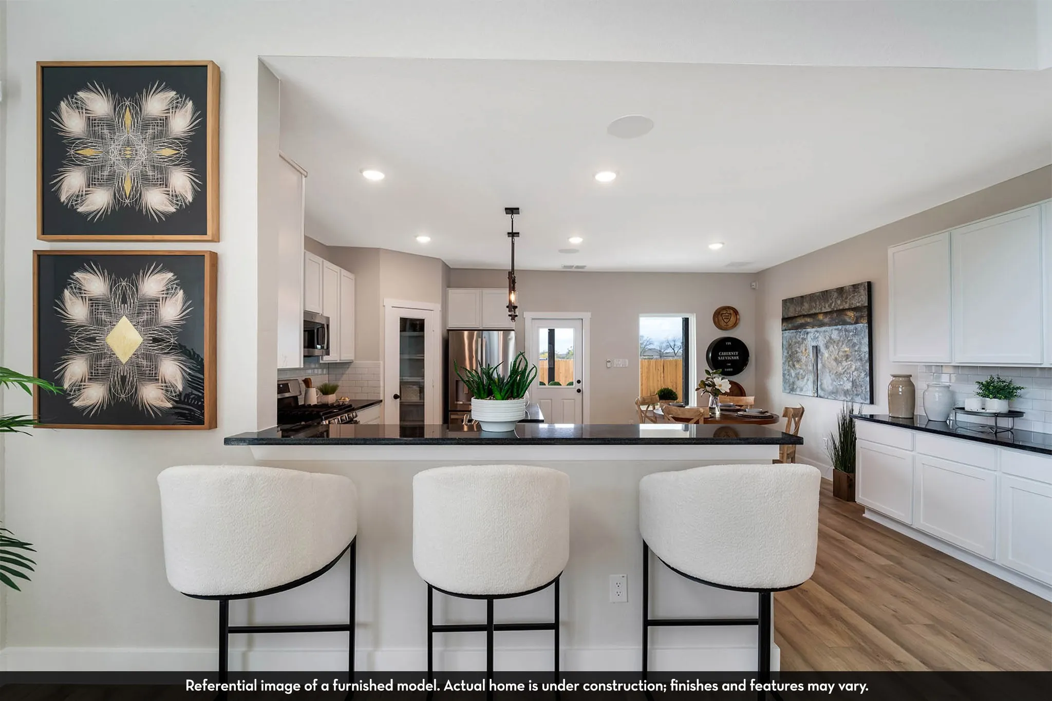 Kitchen island with dark countertop, white cabinetry, wood-finish flooring, and recessed ceiling lighting