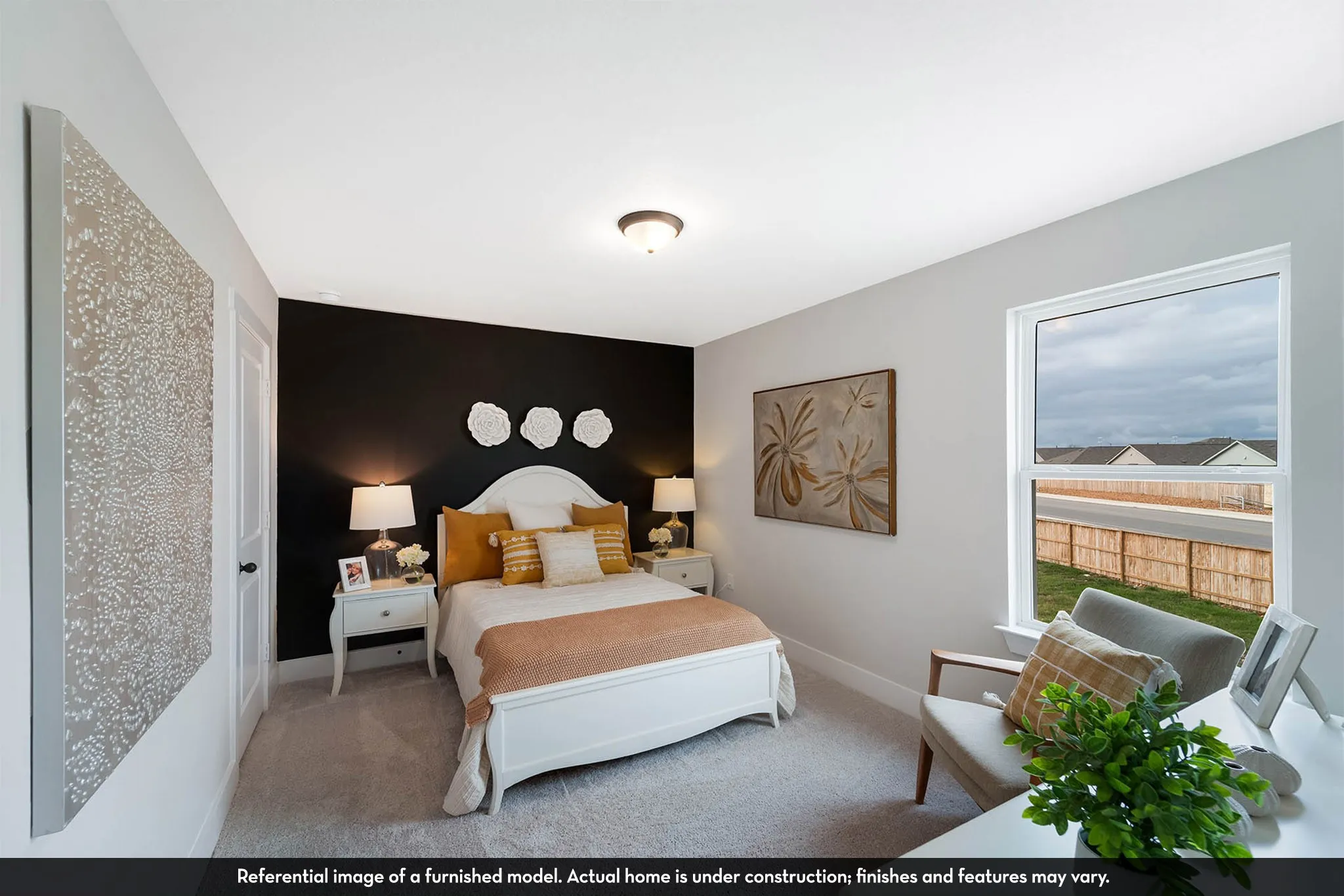 Bright room with a window, dark accent wall, and light-colored carpeting