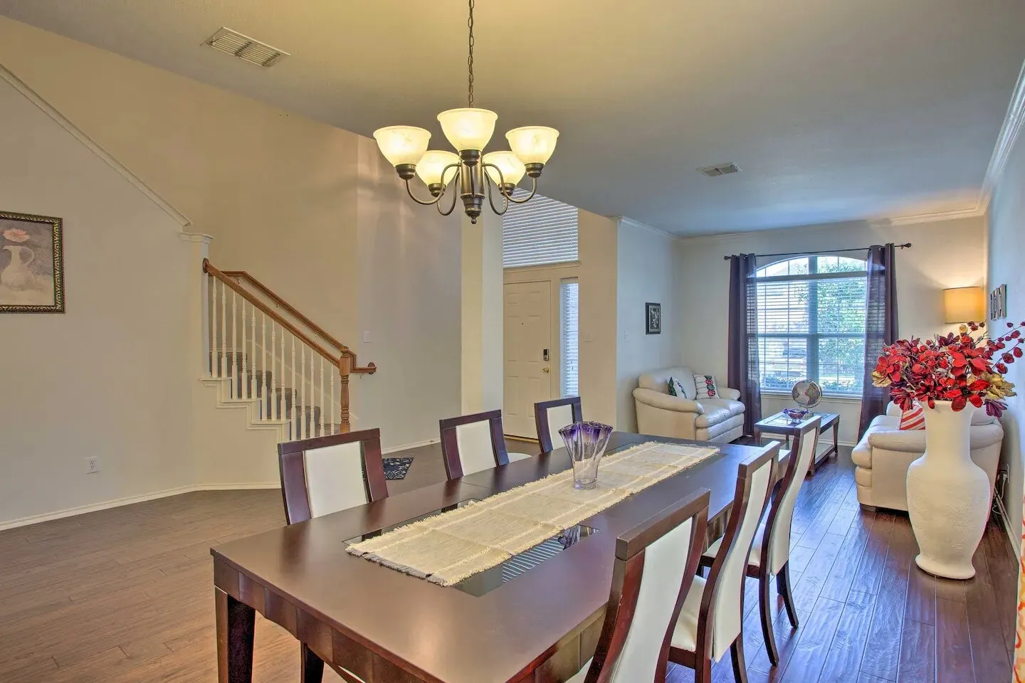 Warm wood-finish flooring extends through the dining area and living space