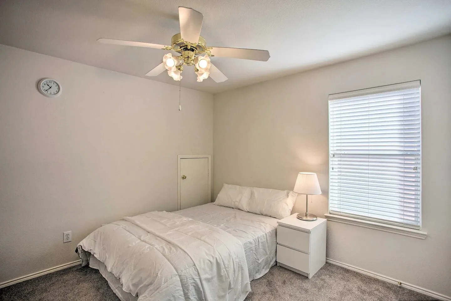 Recessed window with white blinds, wall-to-wall carpeting, and a ceiling fan with integrated lighting