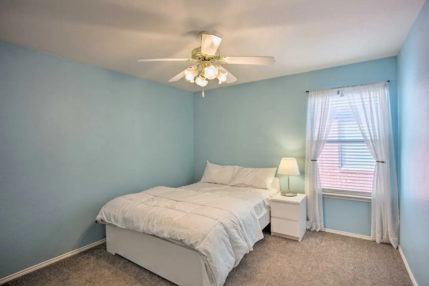 Soft blue wall finish with a white ceiling, featuring a ceiling fan with integrated lighting