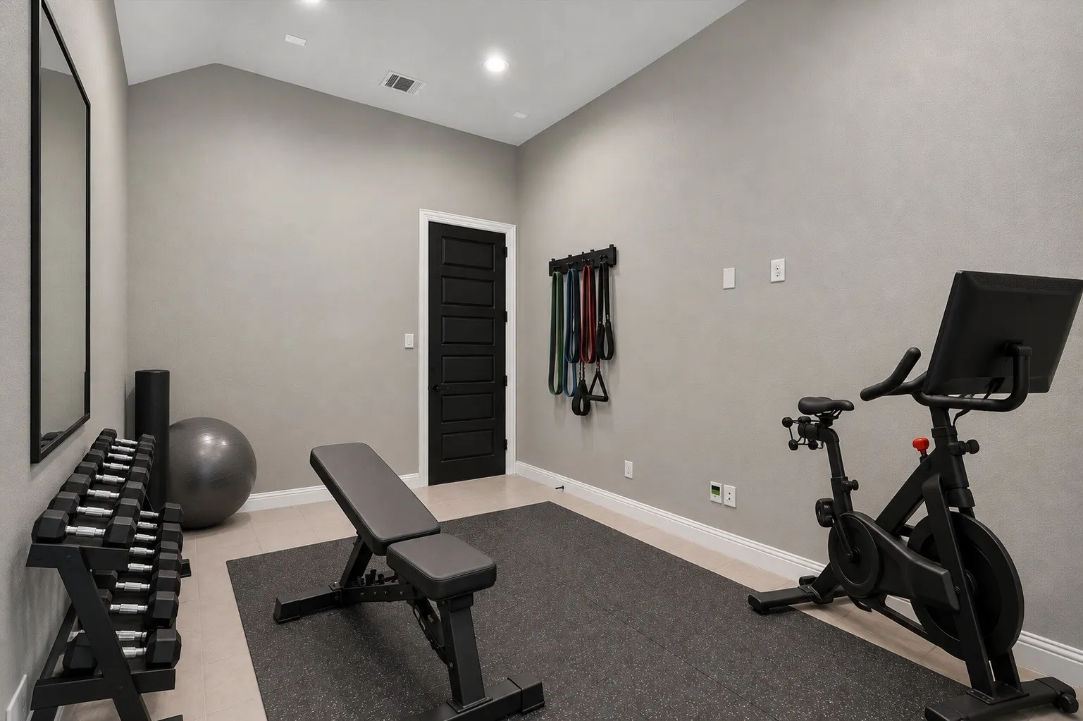 Vaulted ceiling with recessed lighting, light-toned flooring, textured wall finish, and a paneled black interior door