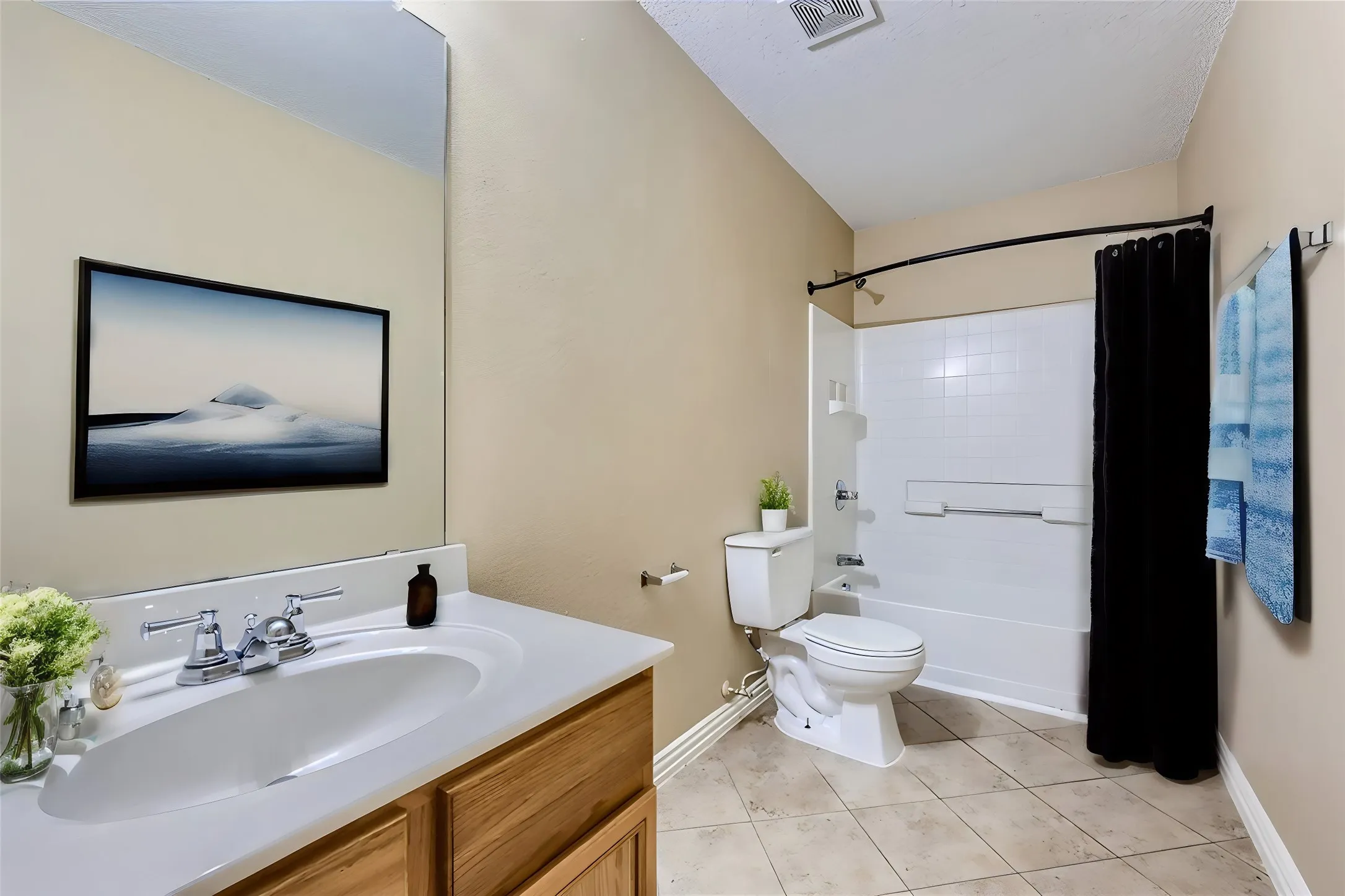 Vanity with an integrated sink, polished chrome faucet, and wood-finish cabinetry