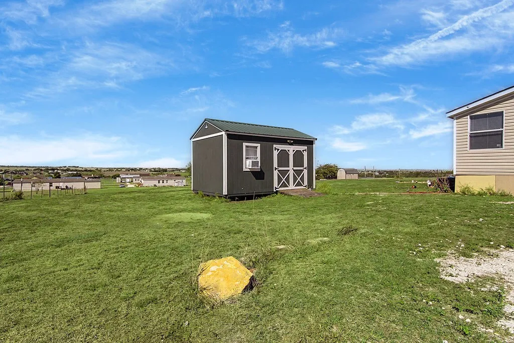 This shed has window unit AC and lighting. Perfect for additional office or hobby space.