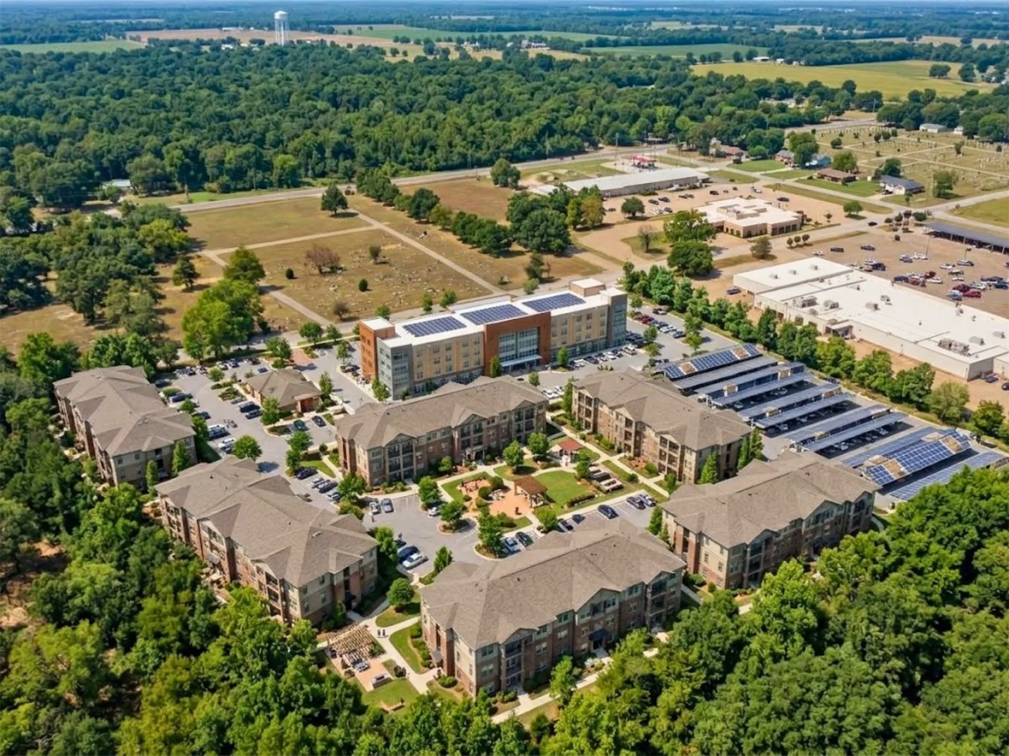 Multi-building development featuring solar panel carports and a central courtyard