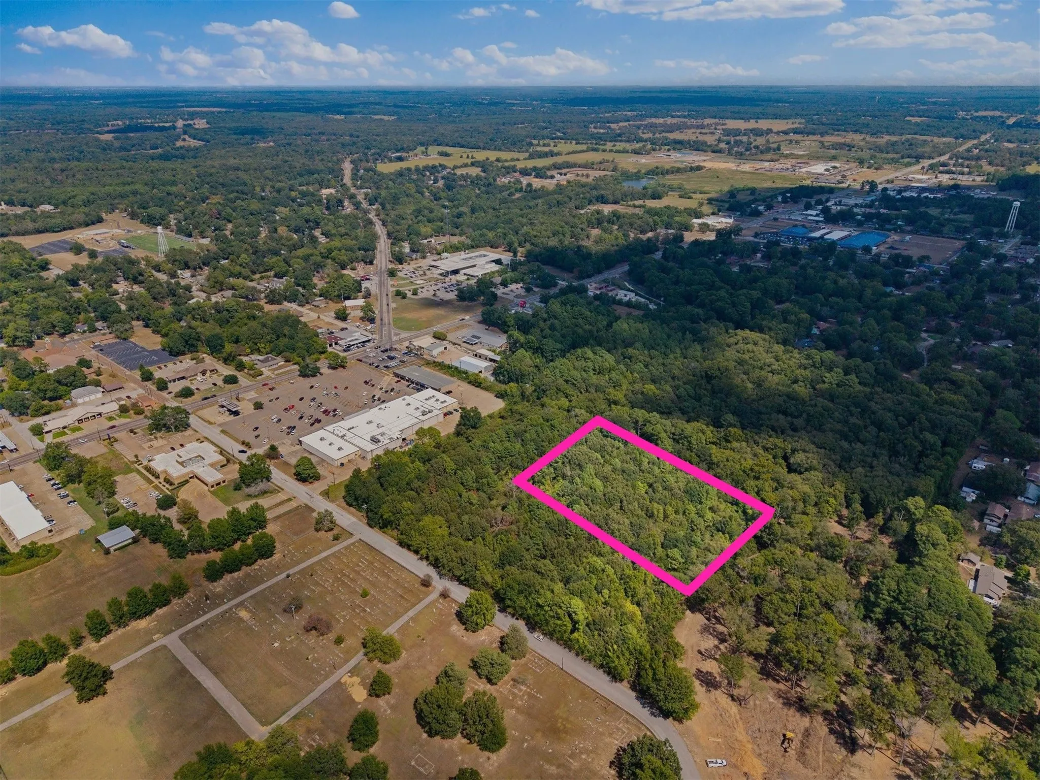 Wooded acreage with established roads and surrounding development