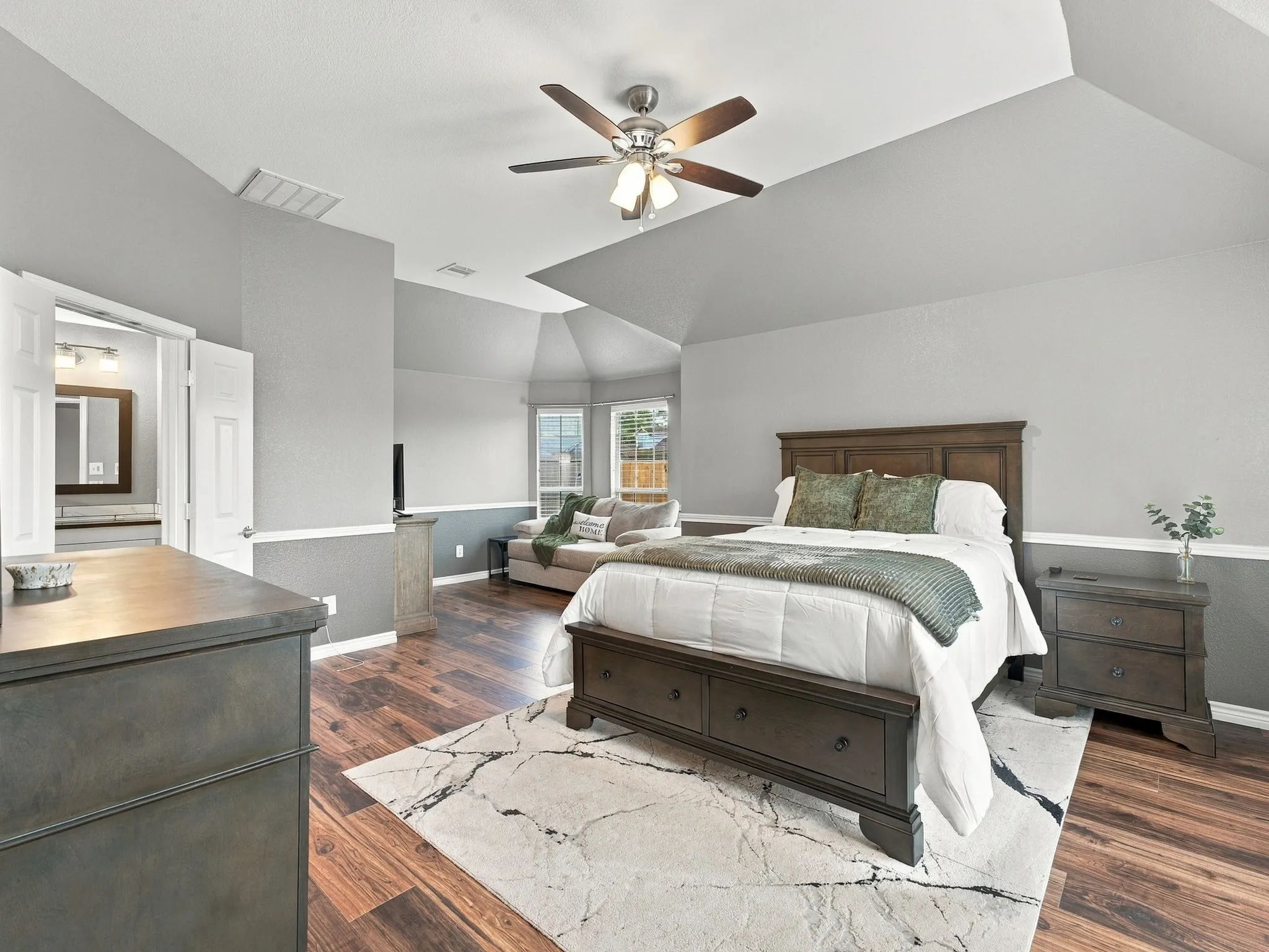 Wood-finish flooring, vaulted ceiling, and dual windows