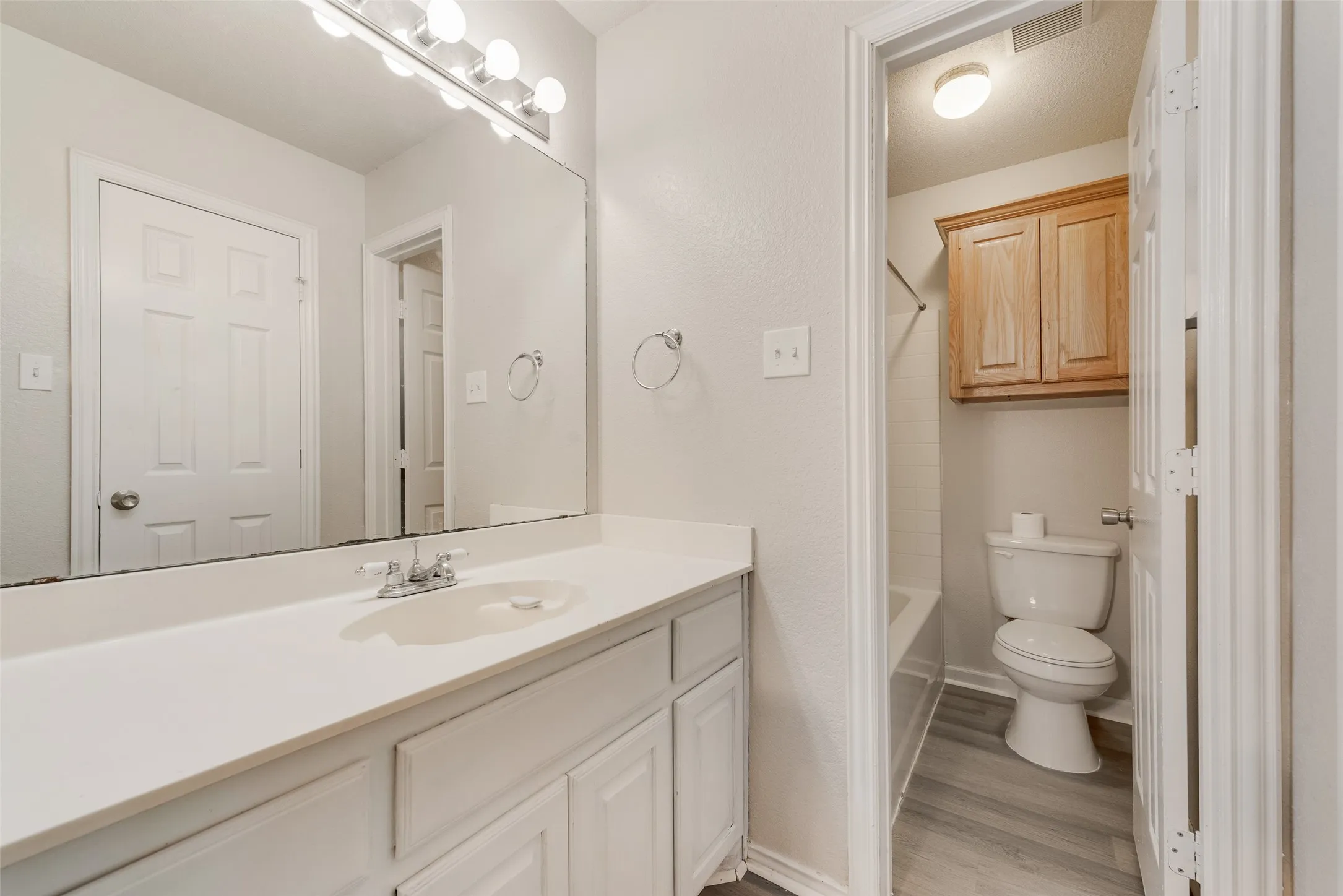 White vanity with an integrated sink and chrome faucet
