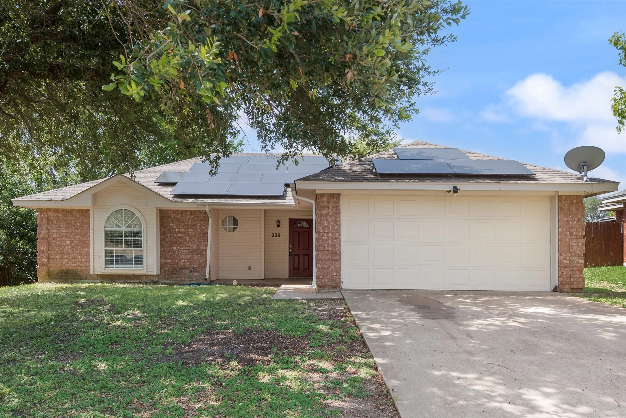 Brick and siding exterior with a single-car garage and concrete driveway