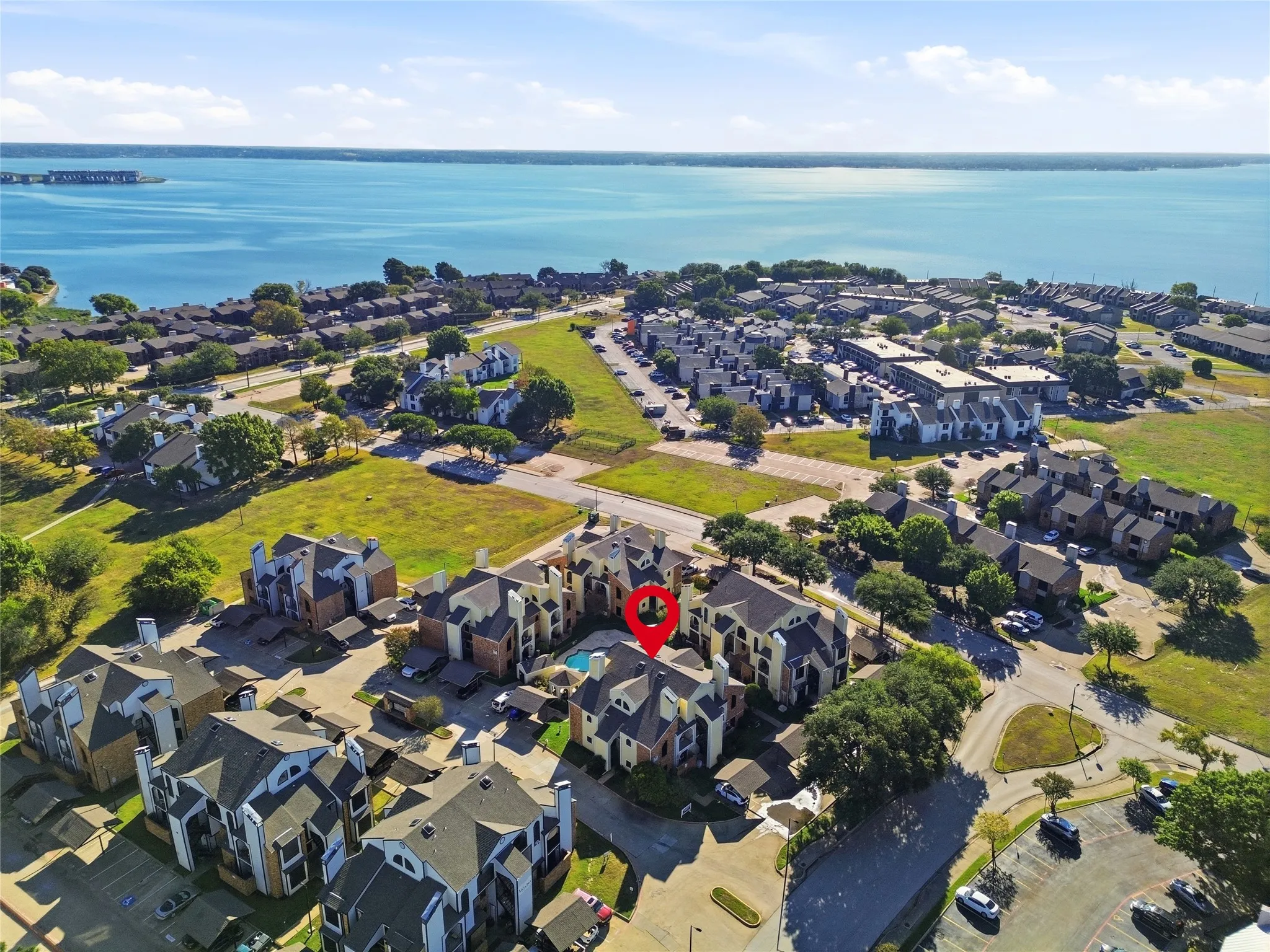Waterfront community featuring multi-story residential buildings and an outdoor swimming pool