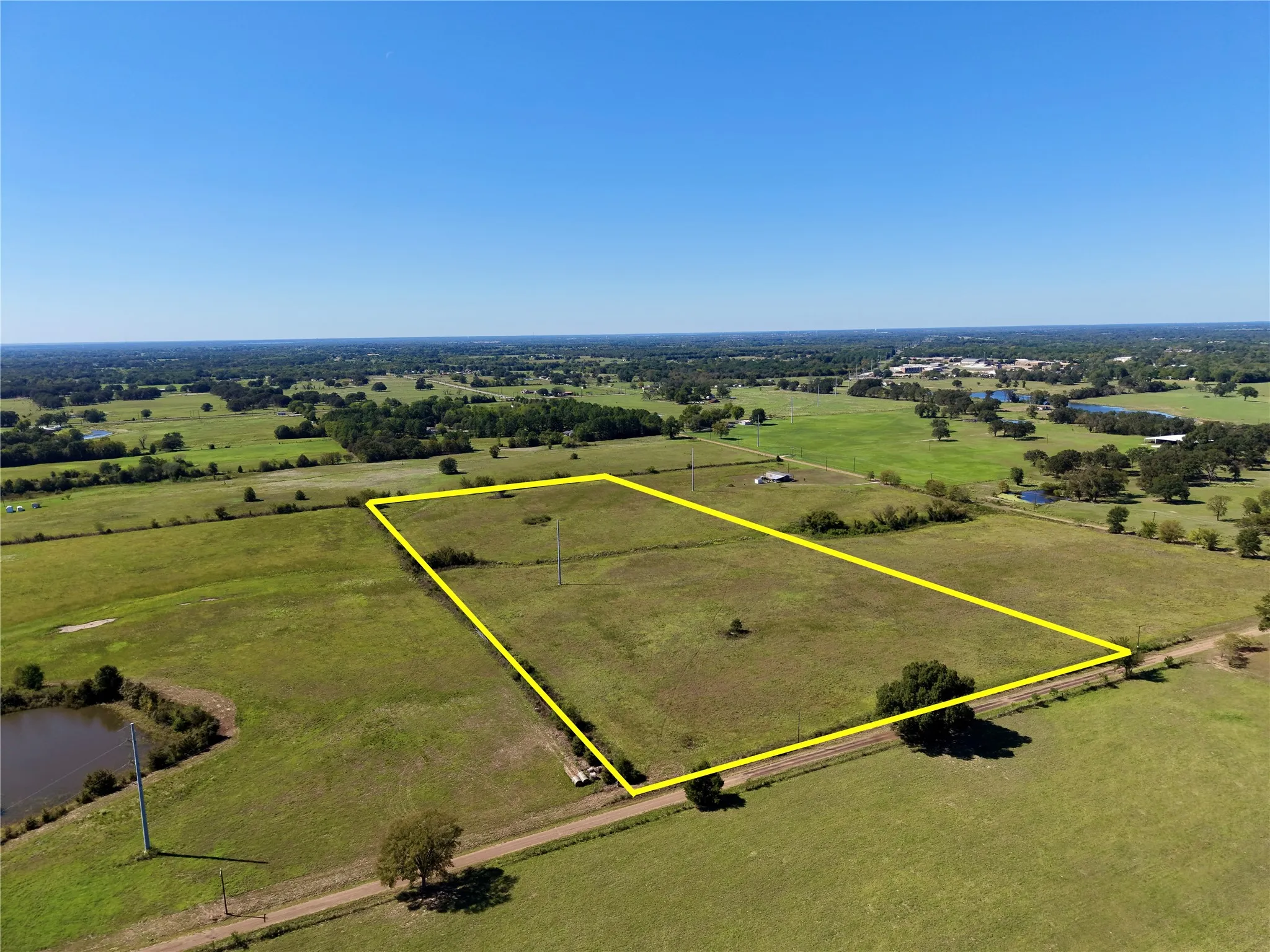 Angled aerial showing the open tract and Goodell Lane road context; outline is approximate.