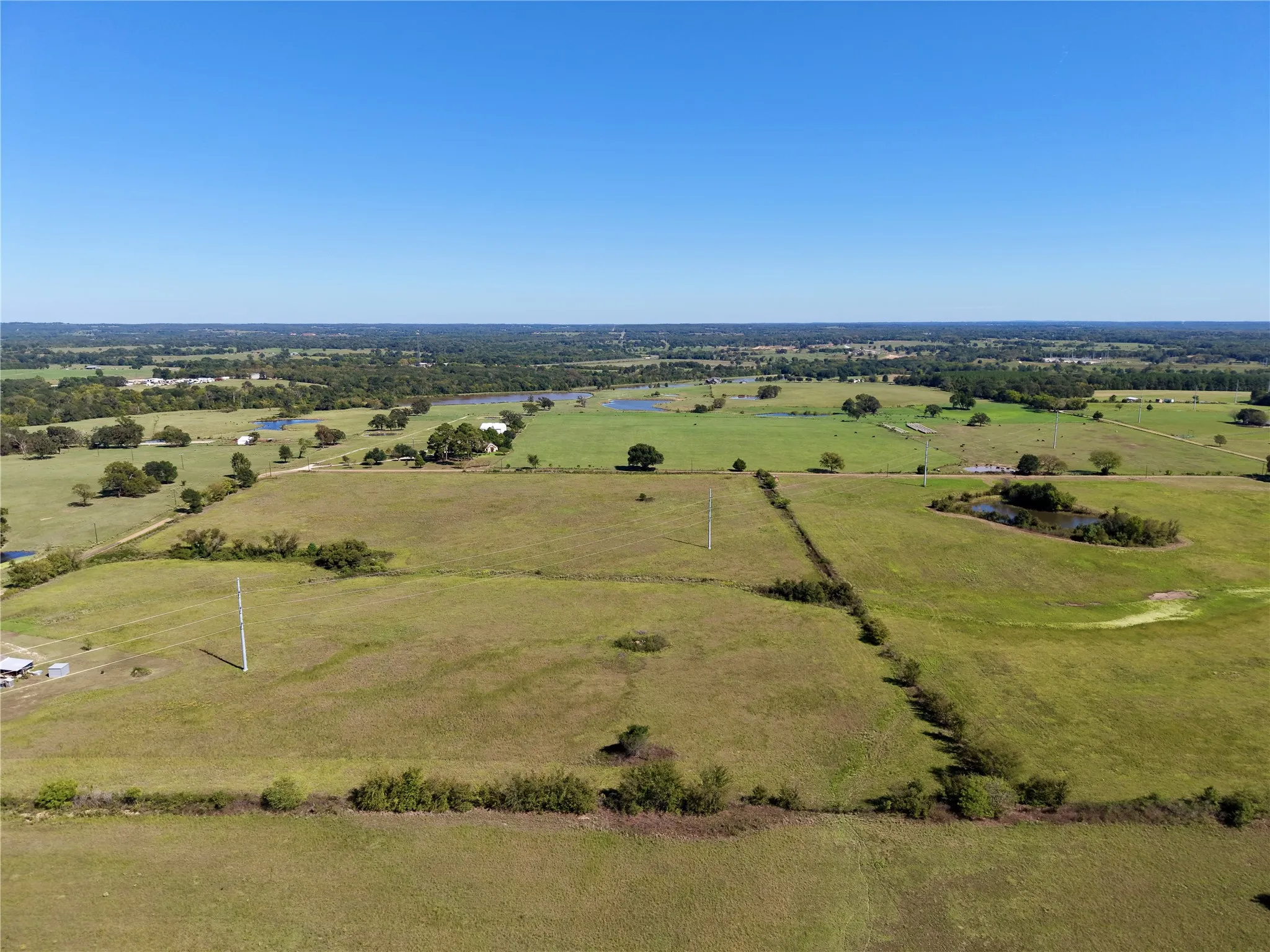 Unoutlined aerial of the tract and surrounding pasture; neighboring land is not included.