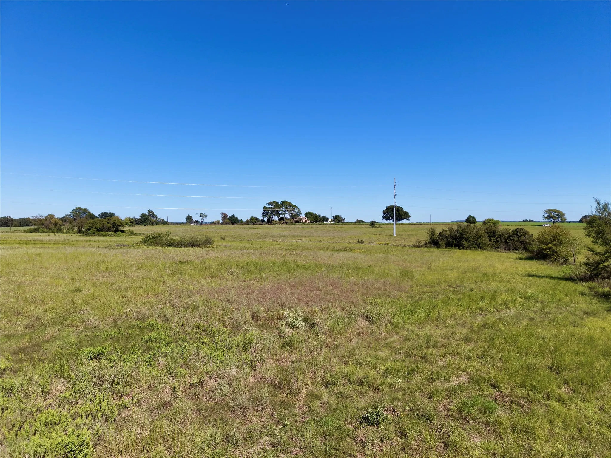 Ground-level view of the open acreage and surrounding rural setting.