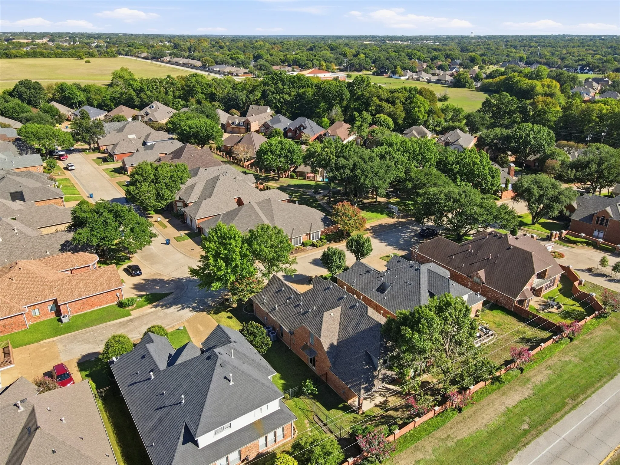 Residential neighborhood with established tree canopy and a paved street