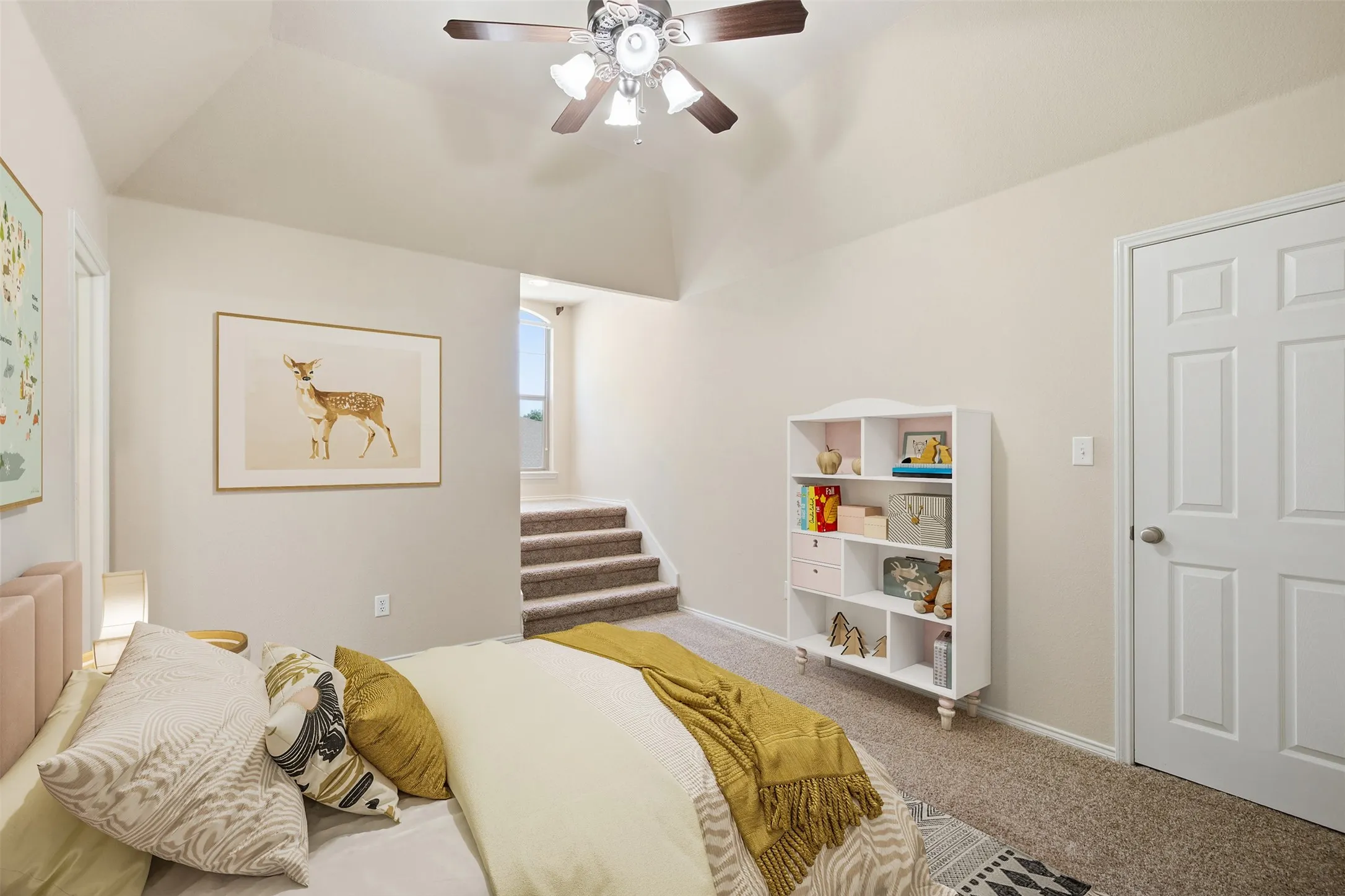 Vaulted ceiling with a ceiling fan. Virtually staged.