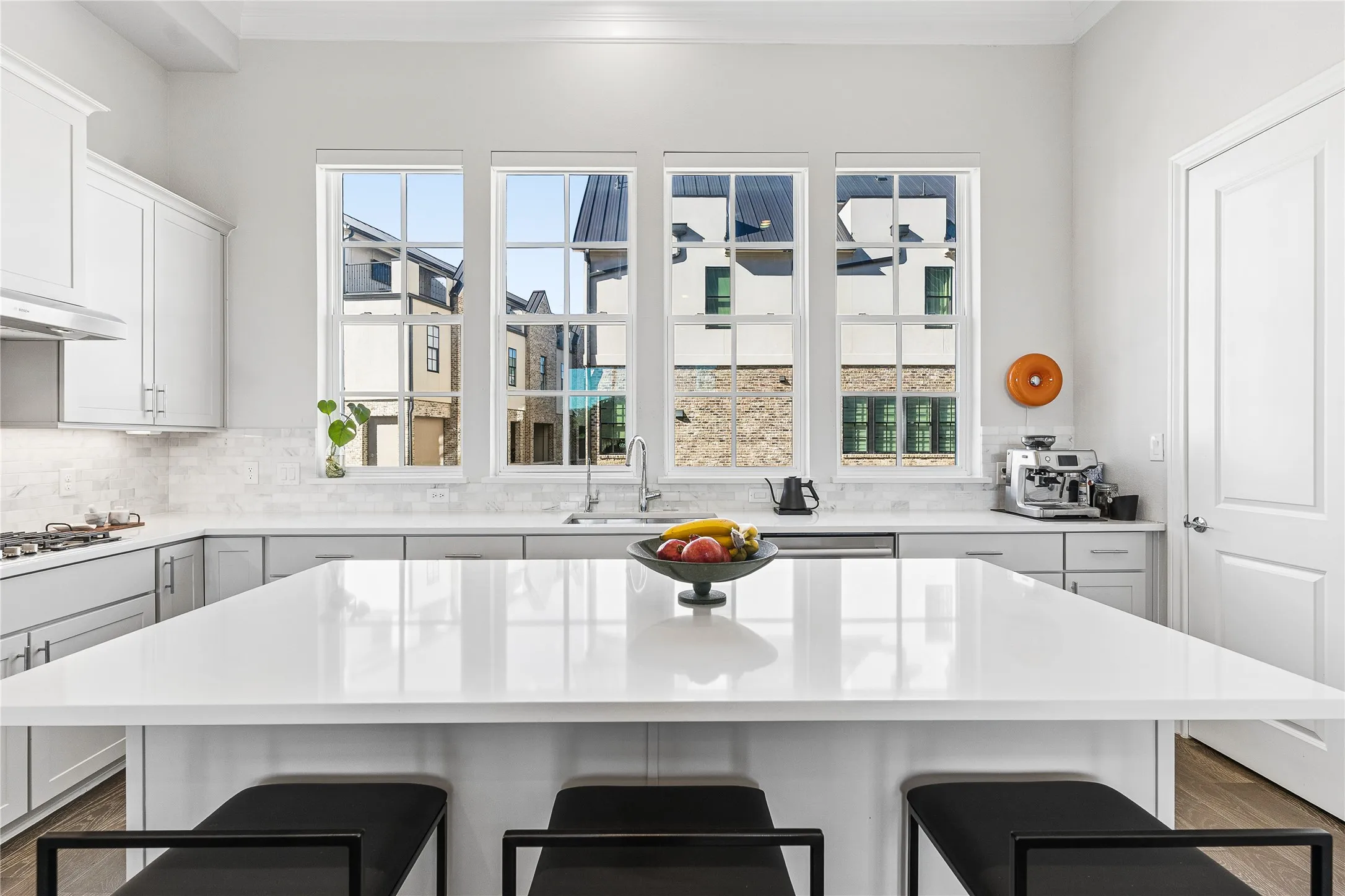 Kitchen features abundant natural light with a warm neutral color pallette.