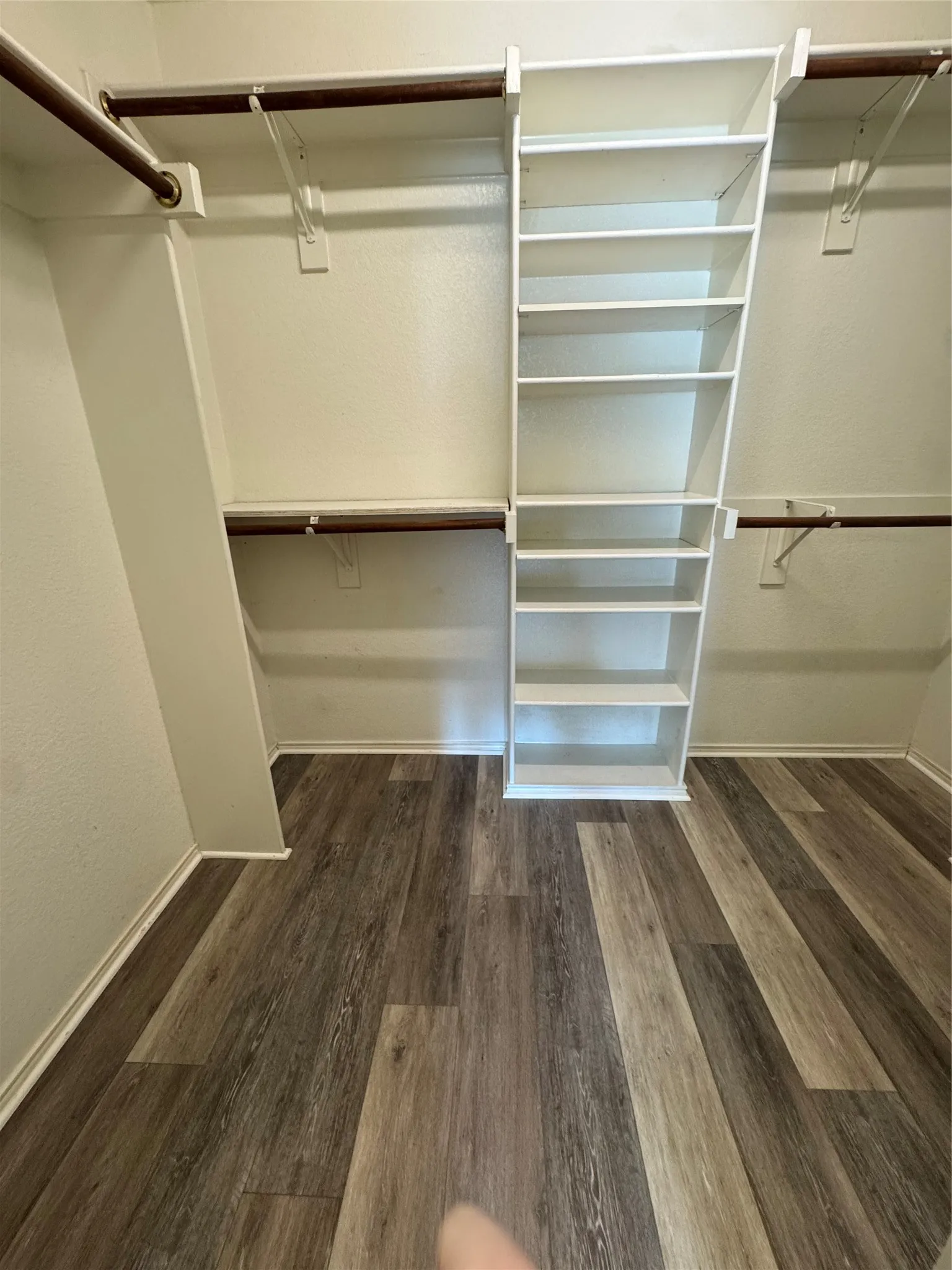 Custom closet organization system with wood-finish flooring