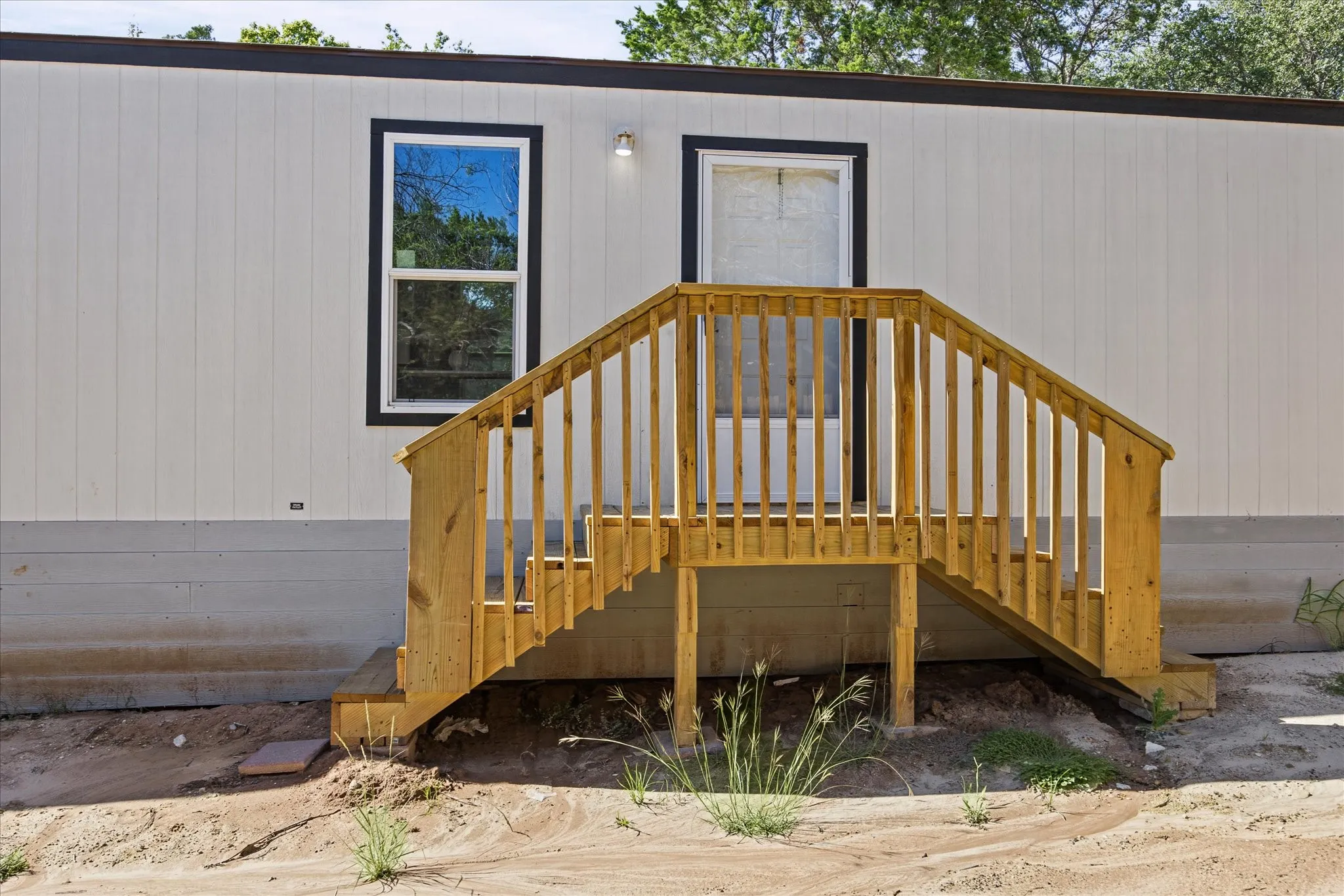White vertical panel siding with black trim windows