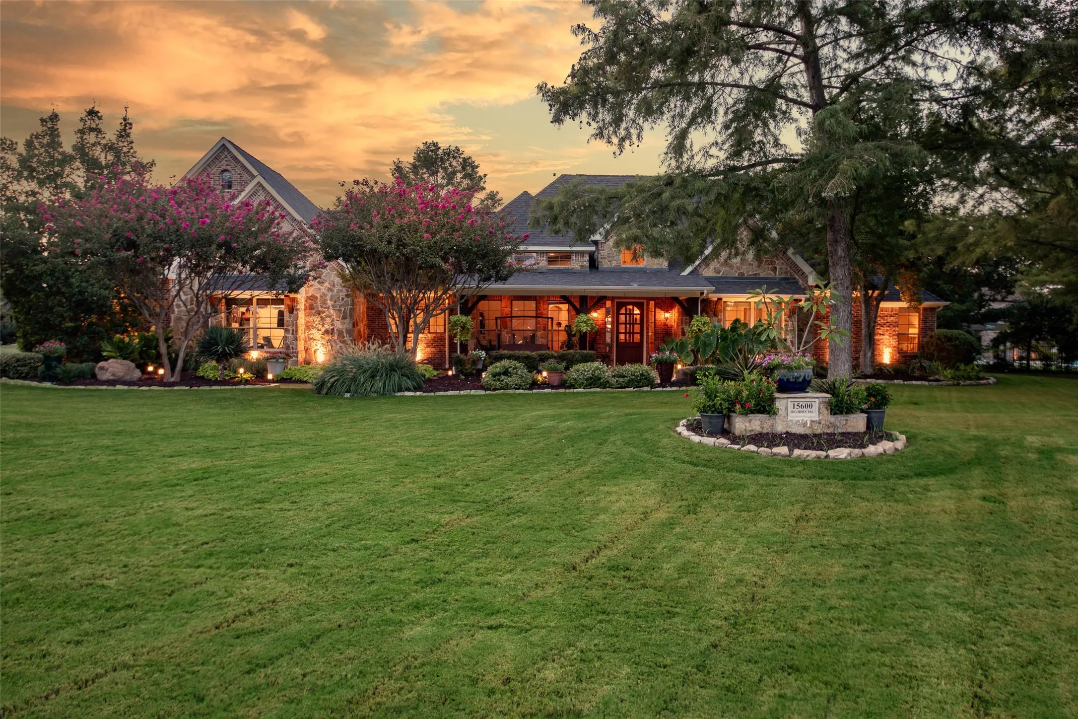 Expansive front lawn with mature trees and established landscaping