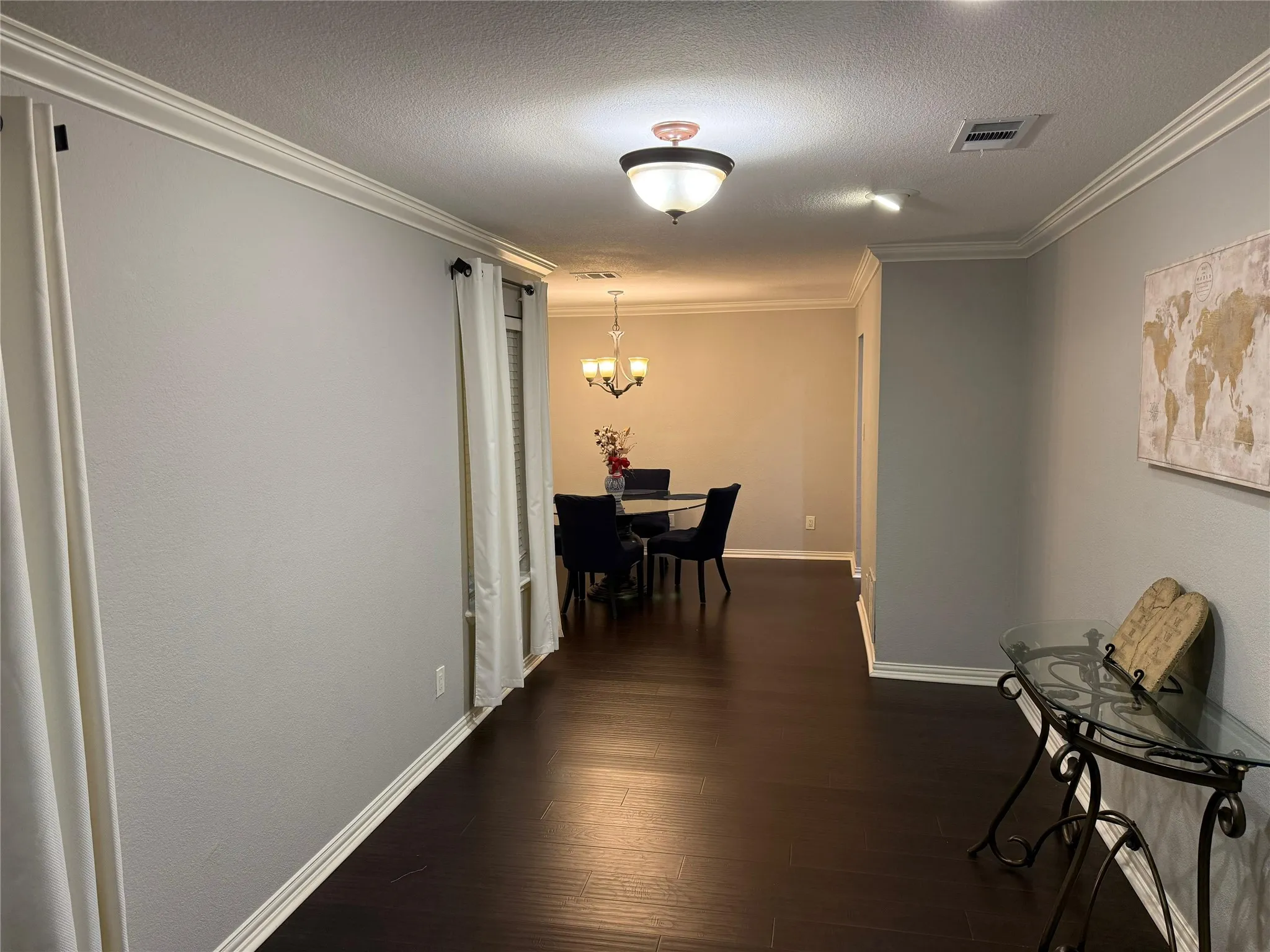 Wood-finish flooring throughout, complemented by crown molding and baseboards