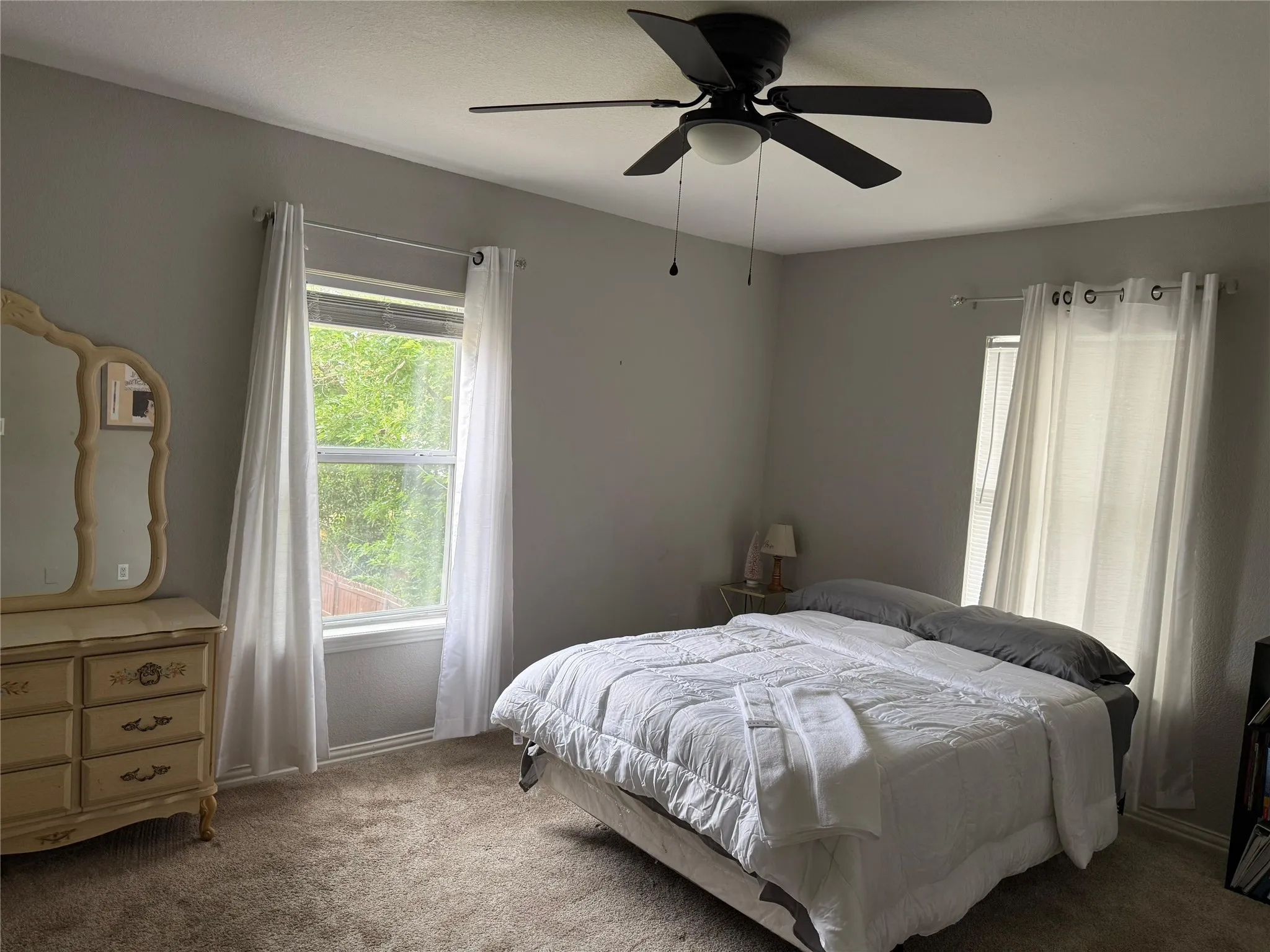 Neutral-toned walls complement plush carpeting