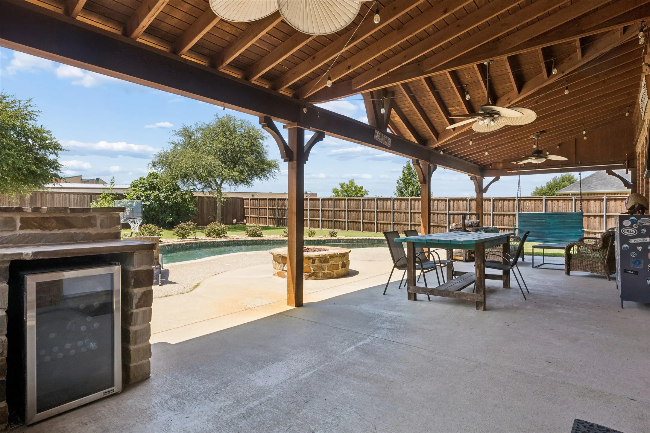 Another great angle of the covered patio overlooking pool and firepit.