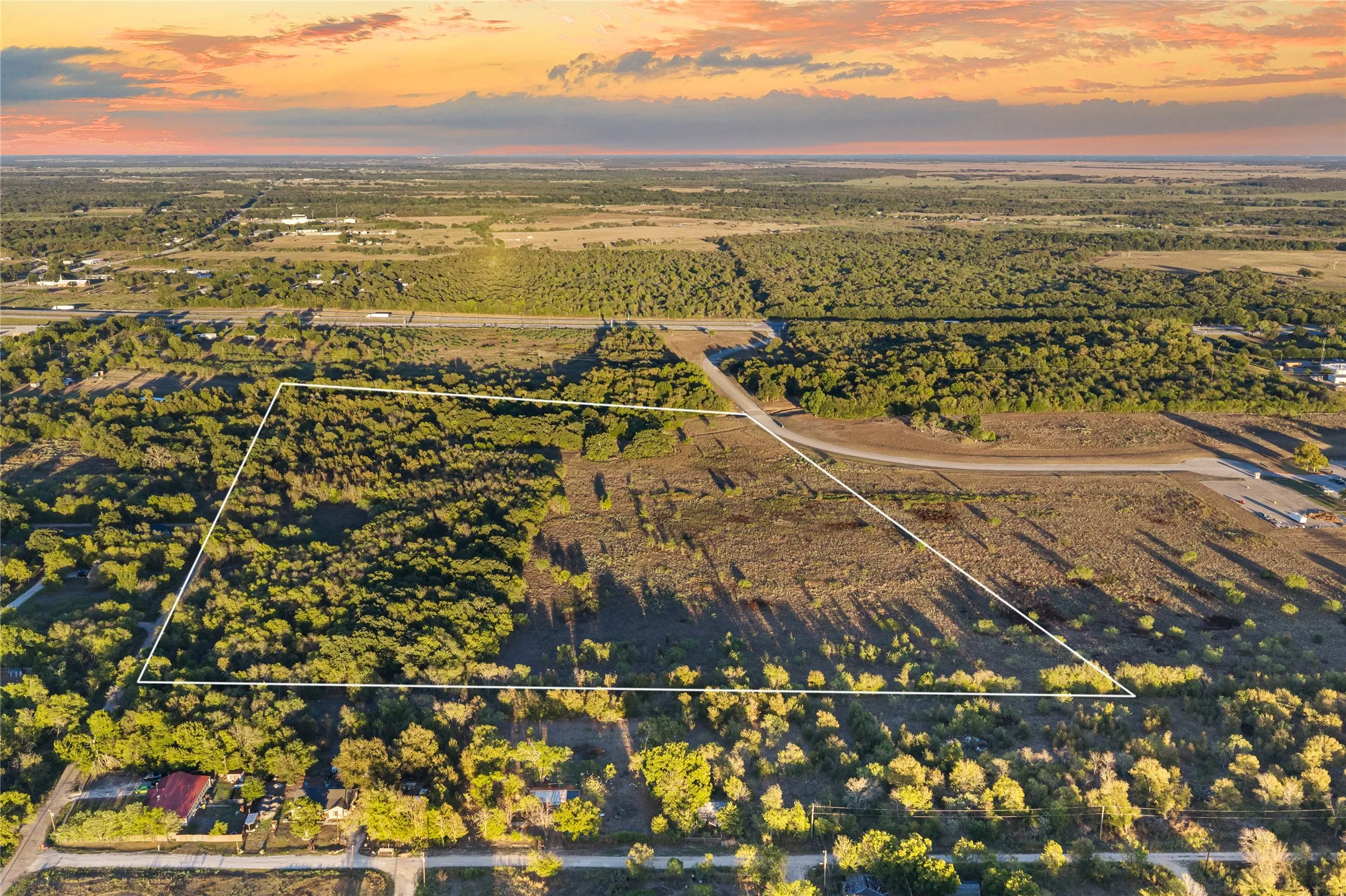Expansive land parcel featuring natural tree coverage and open terrain