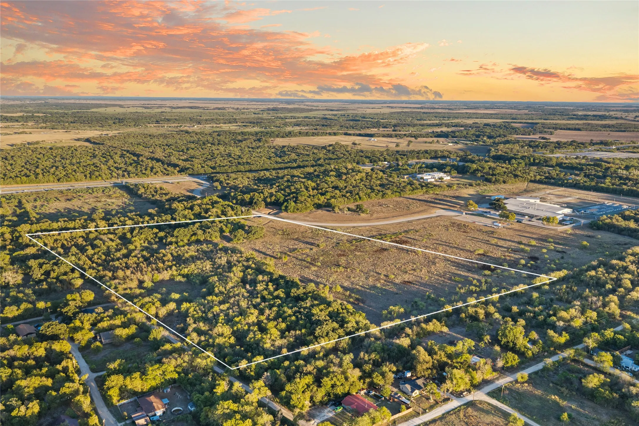 Expansive undeveloped land featuring mature trees and clearings