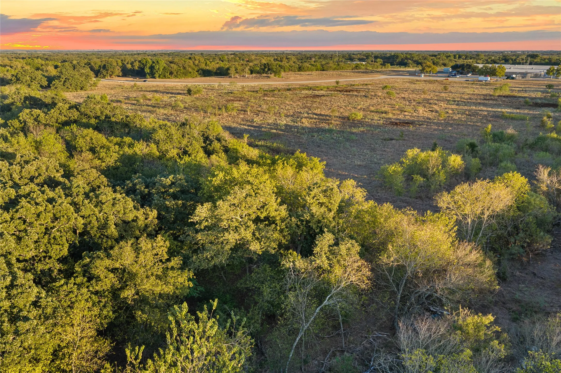 Expansive undeveloped land featuring mature trees and open fields