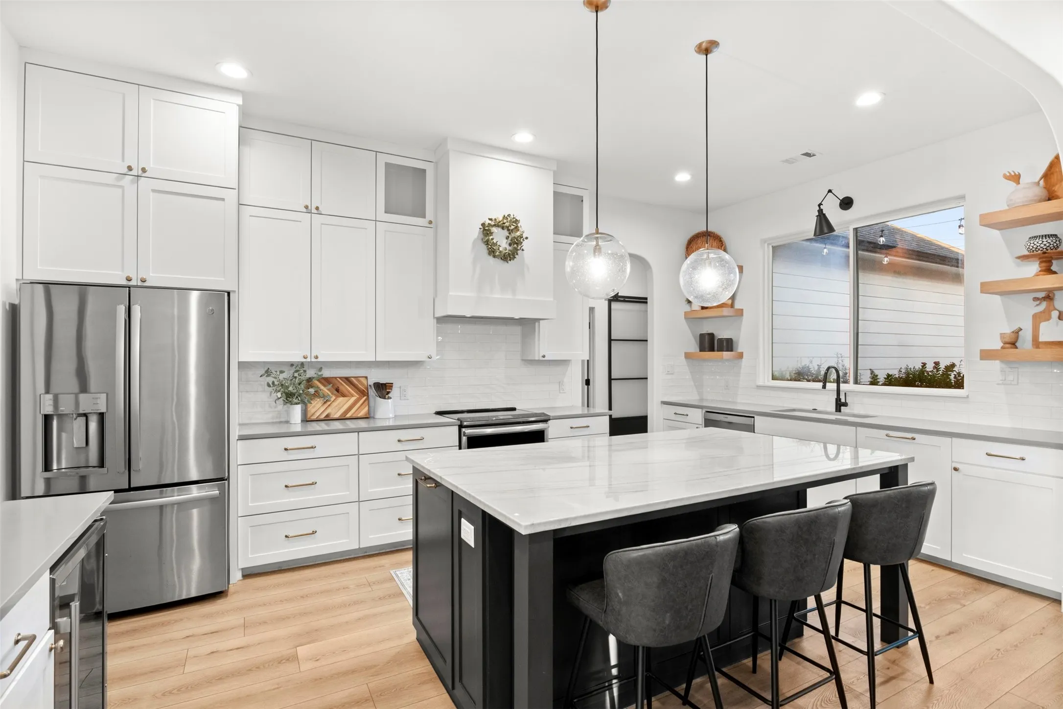 Oversized contrasting island offers generous prep space, seating and additional drawer storage.